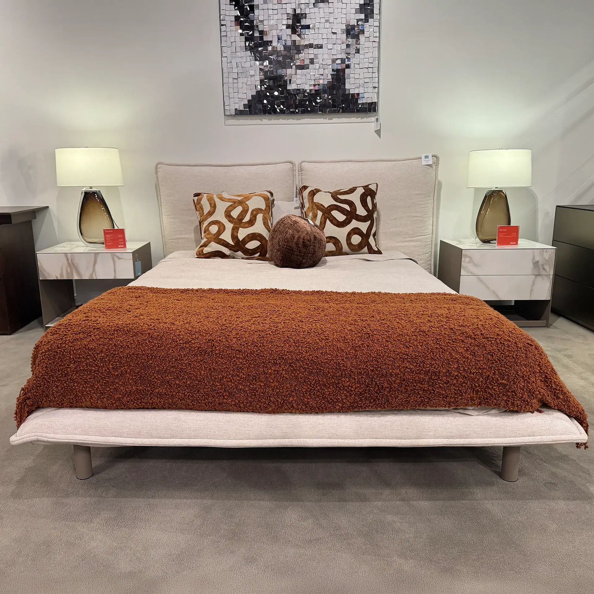Modern bedroom with Trica Haven queen bed, decorative pillows, and stylish lamps.