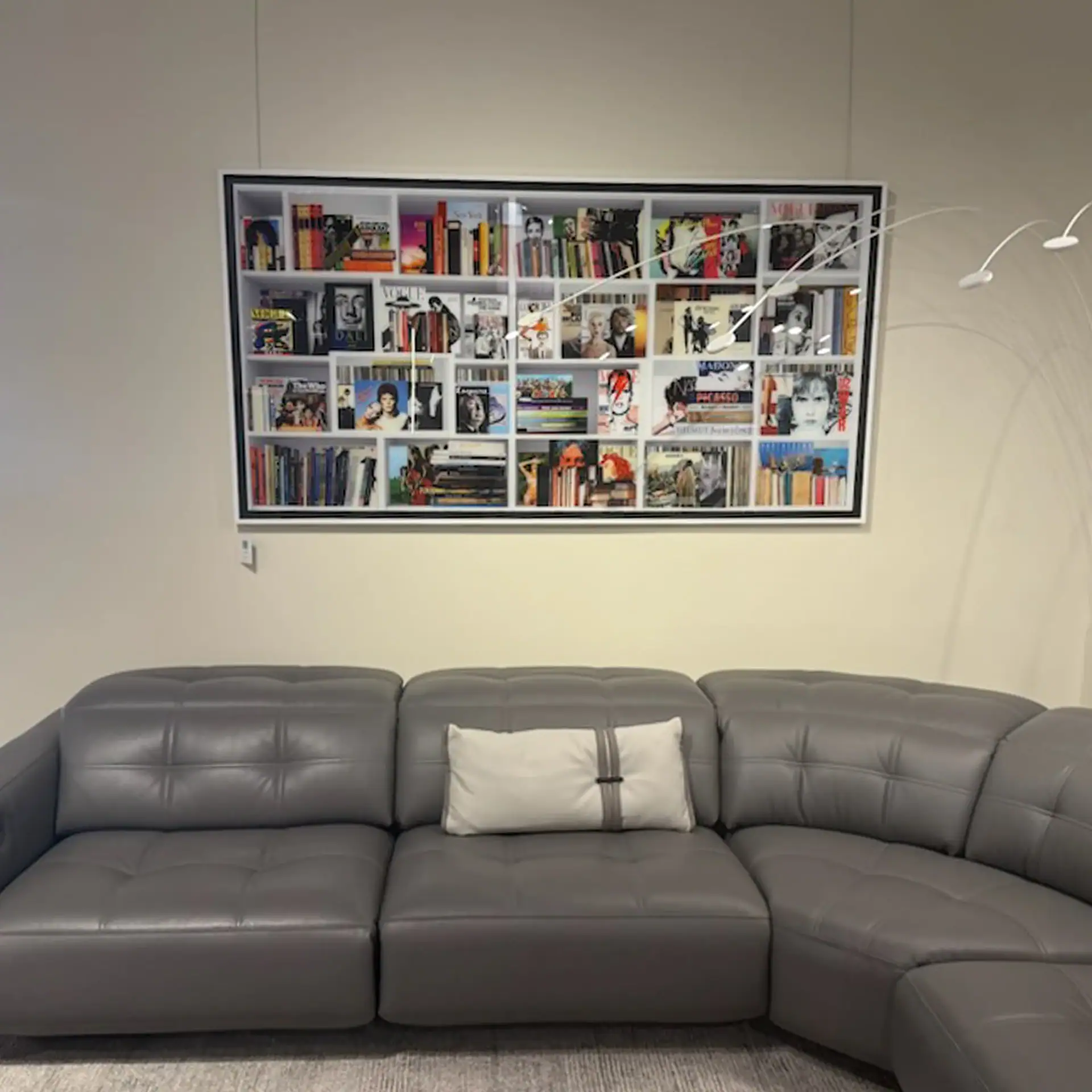 Contemporary bookshelf wall art with books and decorative items.