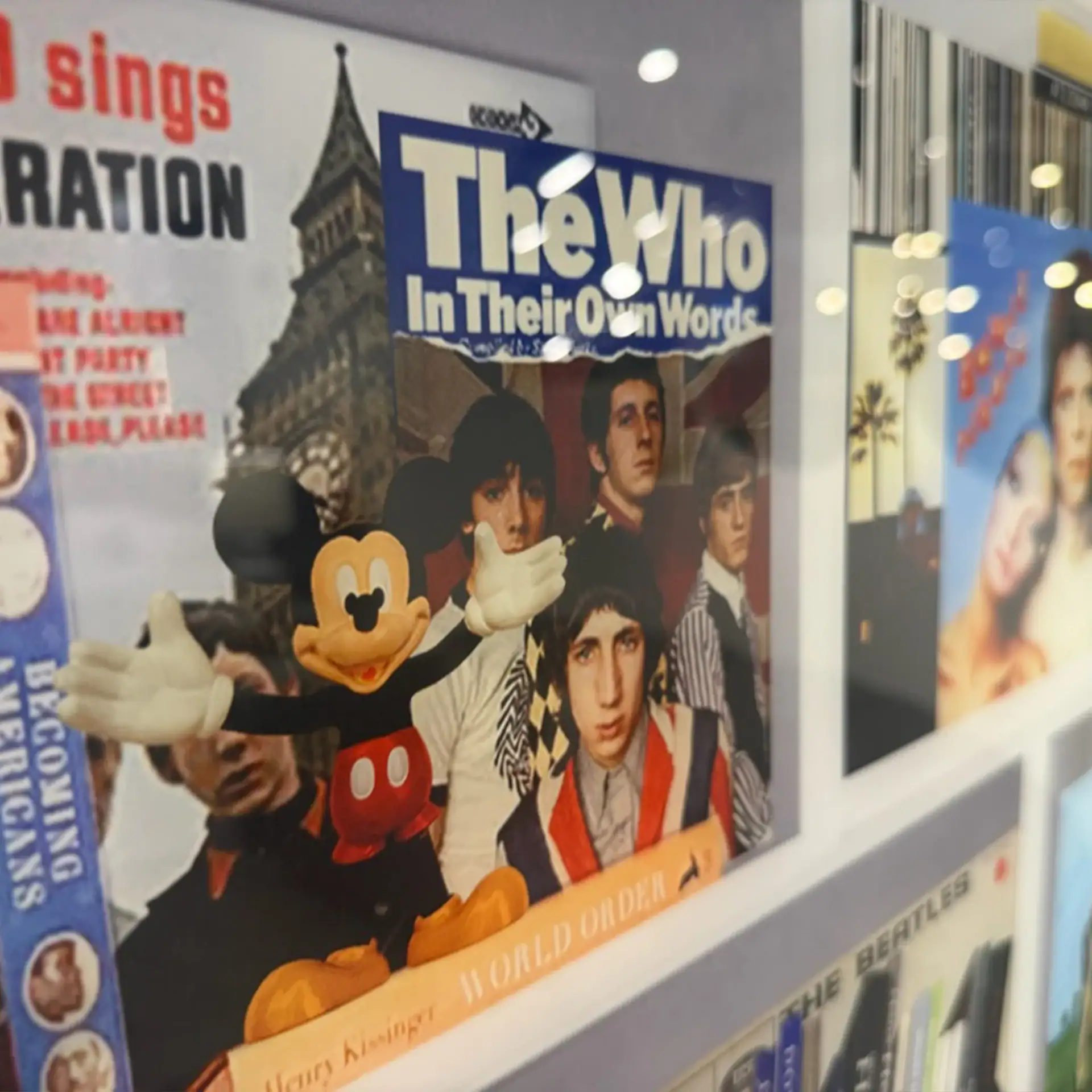 Display of music books and plexiglass art featuring The Who band.