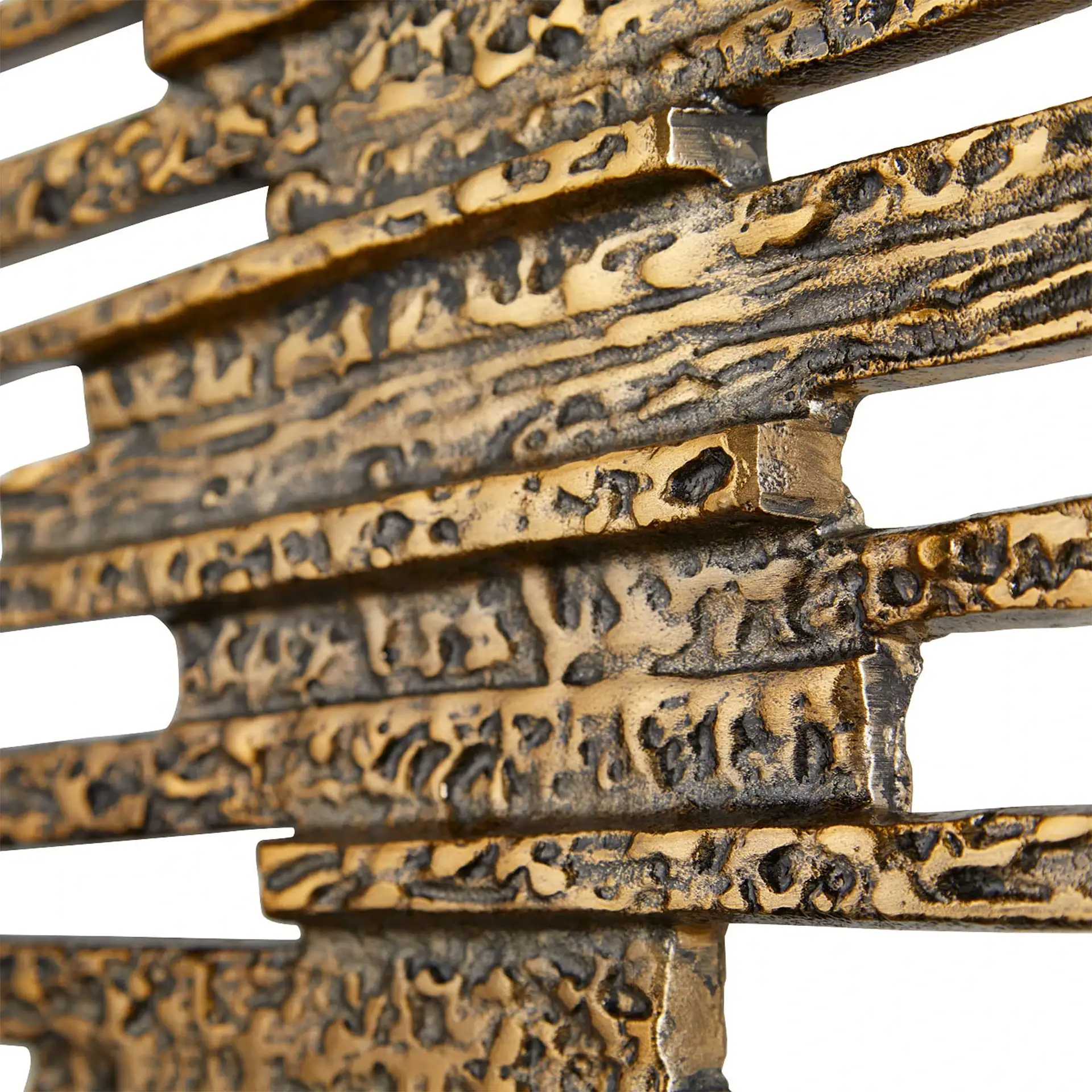 Close-up of rustic metal ledger wall decor with textured finish.