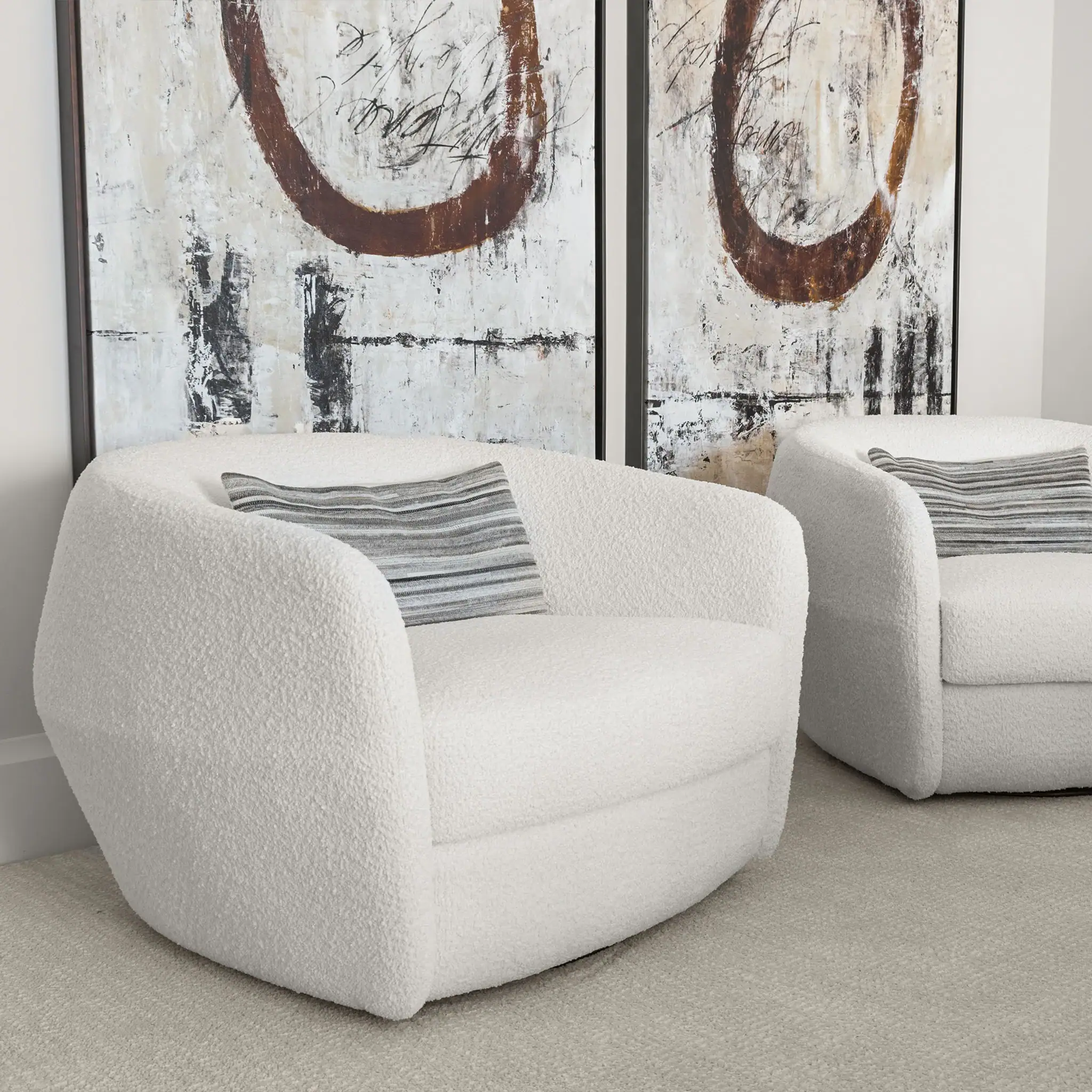 Contemporary white upholstered armchairs with plush cushions for stylish living room seating.