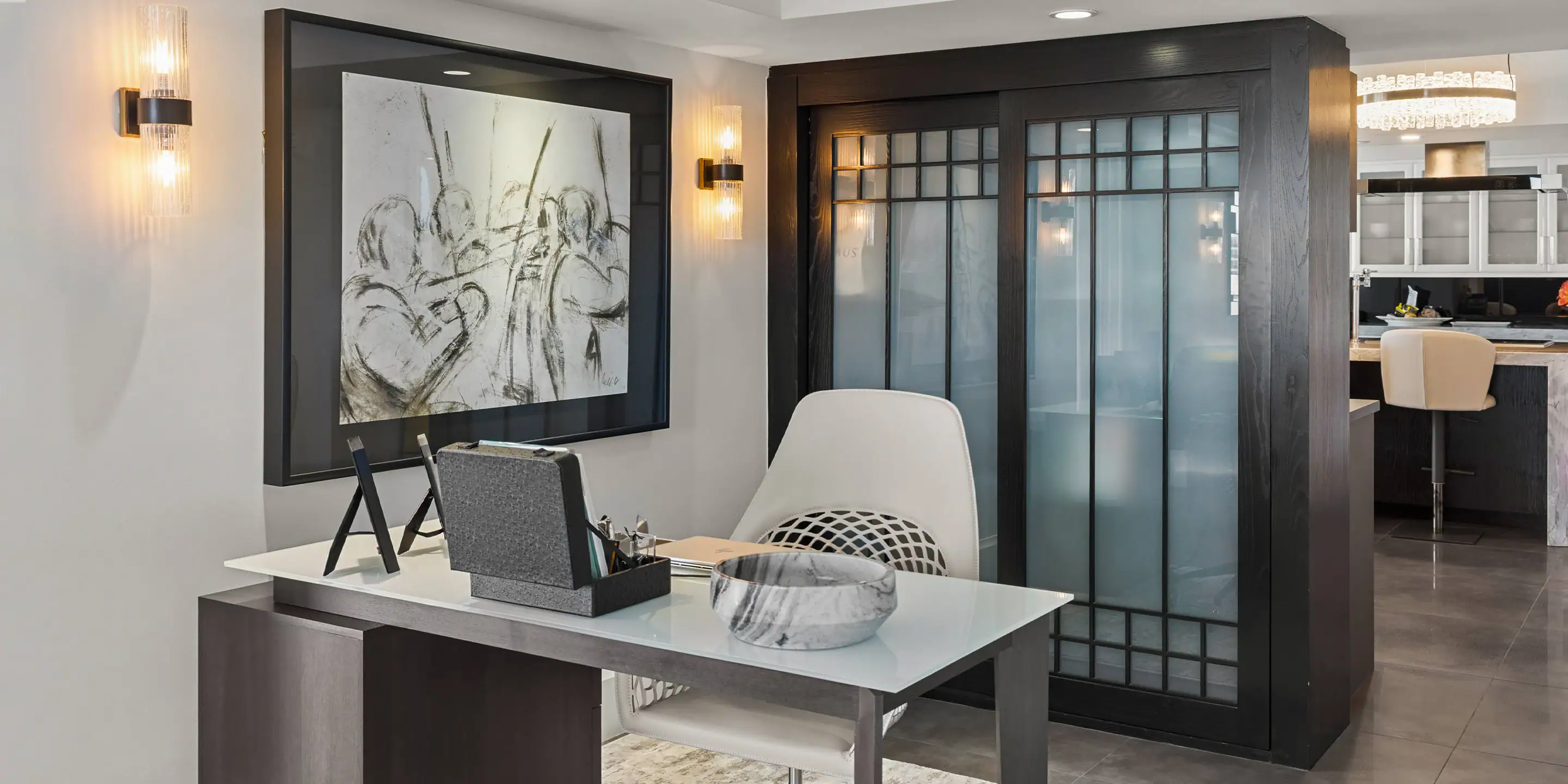 Modern office workspace featuring a sleek glass partition and contemporary furniture.