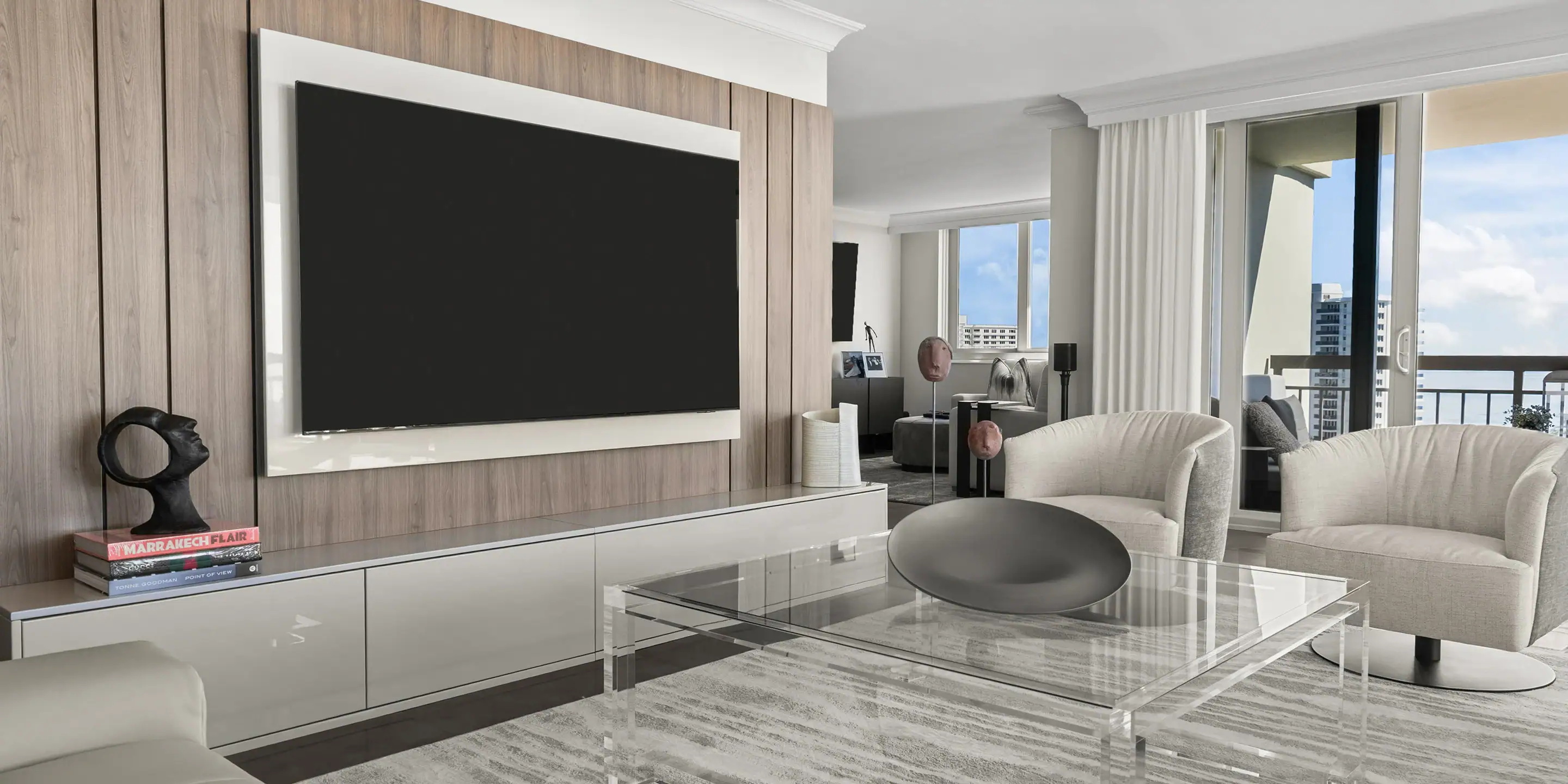 Wall-mounted flat-screen TV in a contemporary living room with stylish furniture and large windows o.