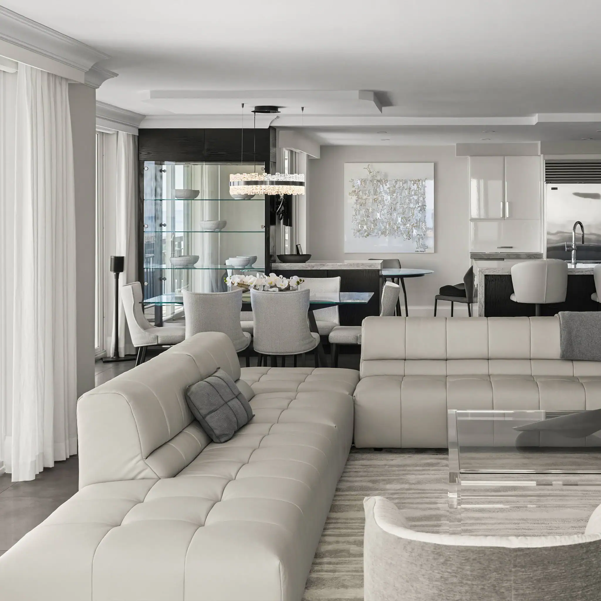 Elegant white leather sectional sofa with plush cushions in a stylish modern living space.