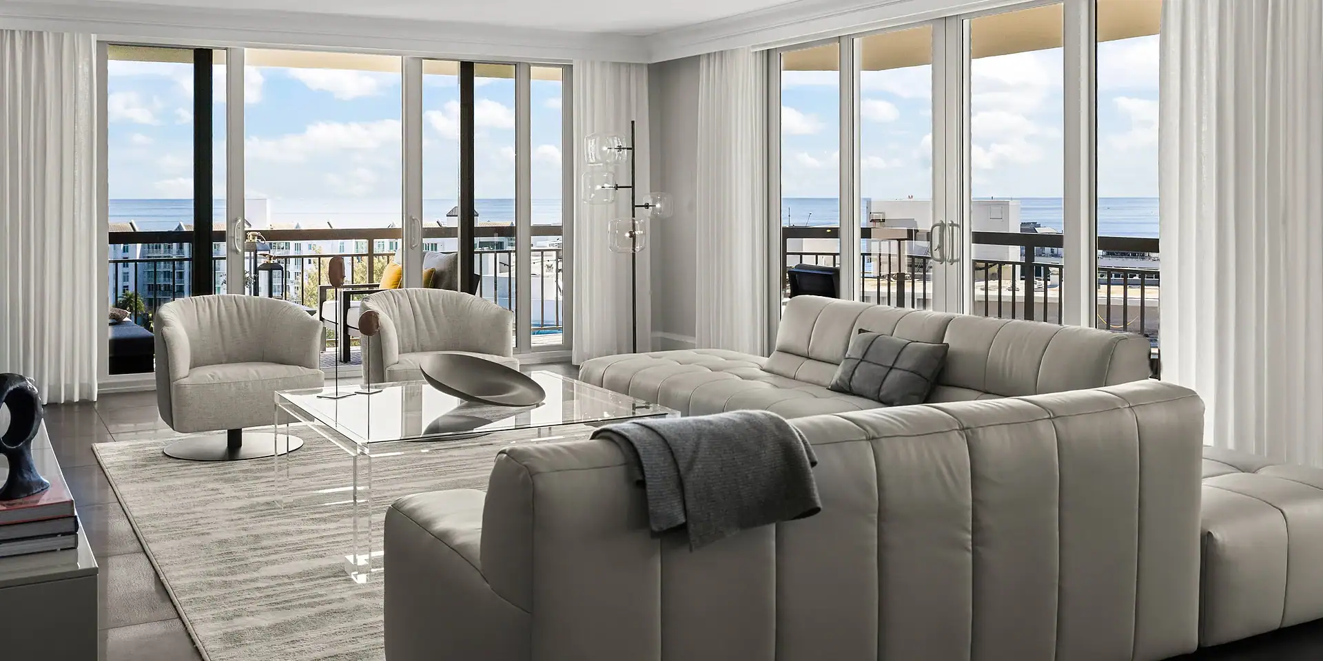 Bright living room with large windows overlooking the ocean.
