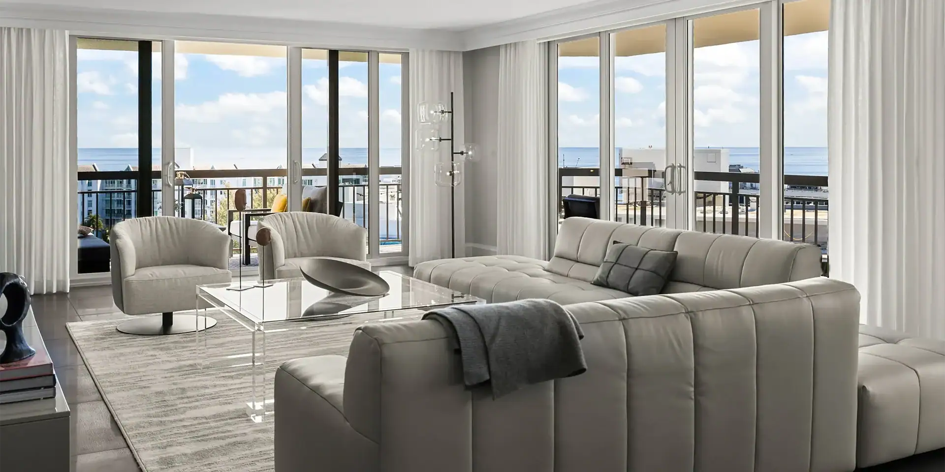 Bright living room with large windows overlooking the ocean.