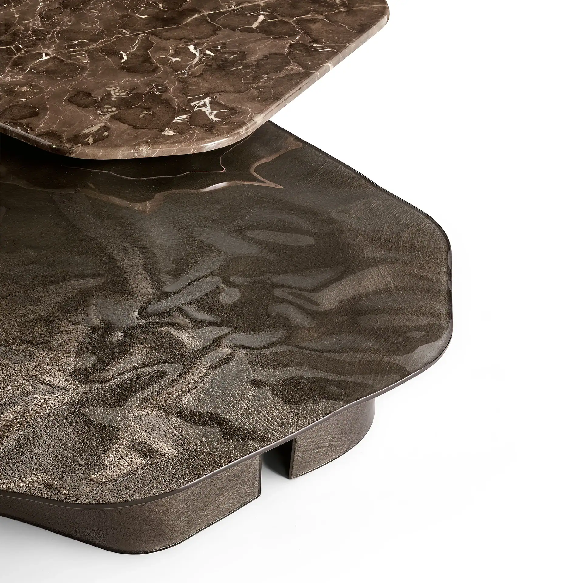 Close-up of the textured, dark brown marble and wood coffee table surface.
