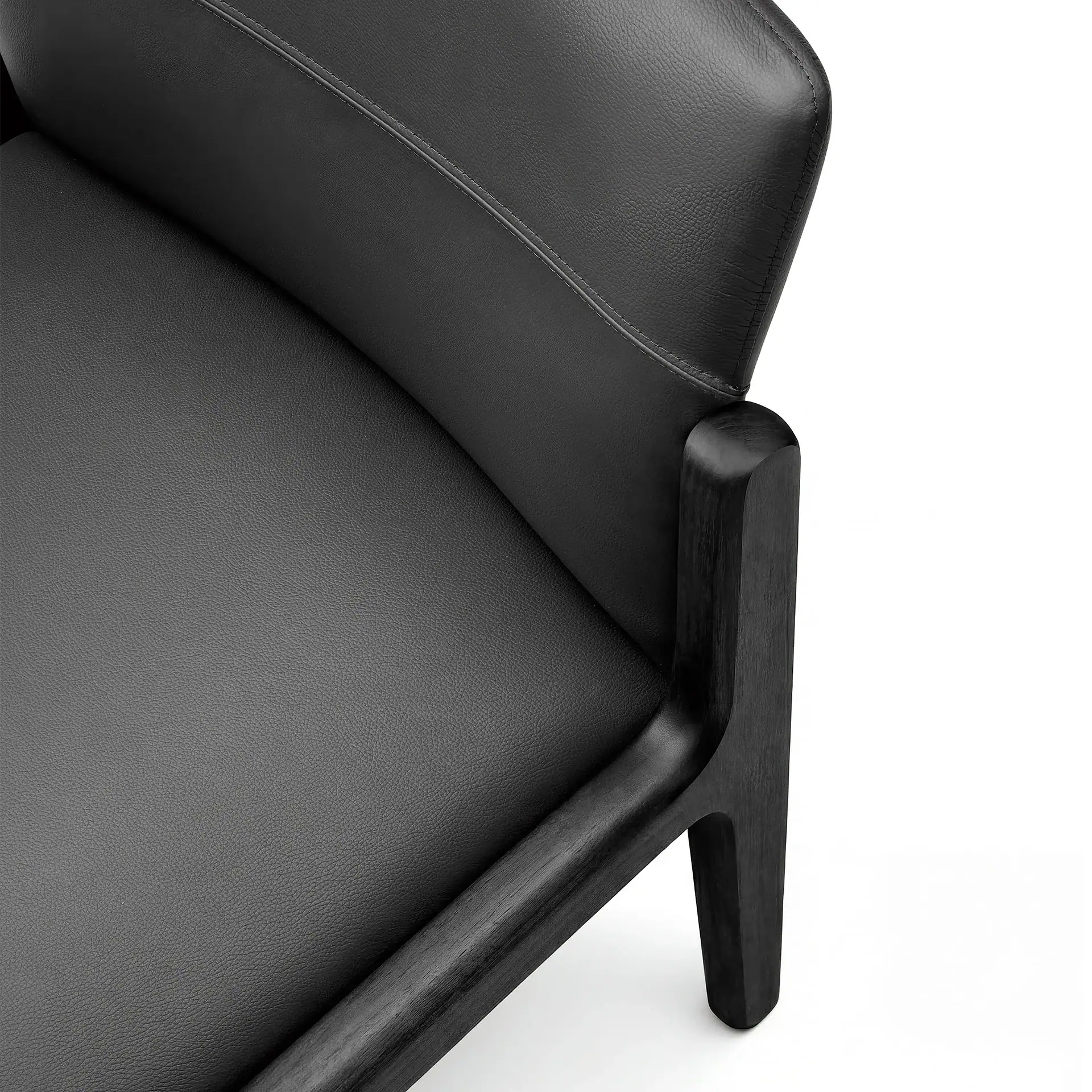 Modern black chair with wooden armrest and sleek design.