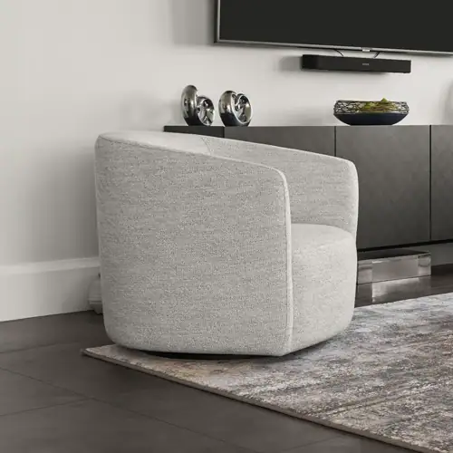 Contemporary grey upholstered armchair in a stylish living room setting.