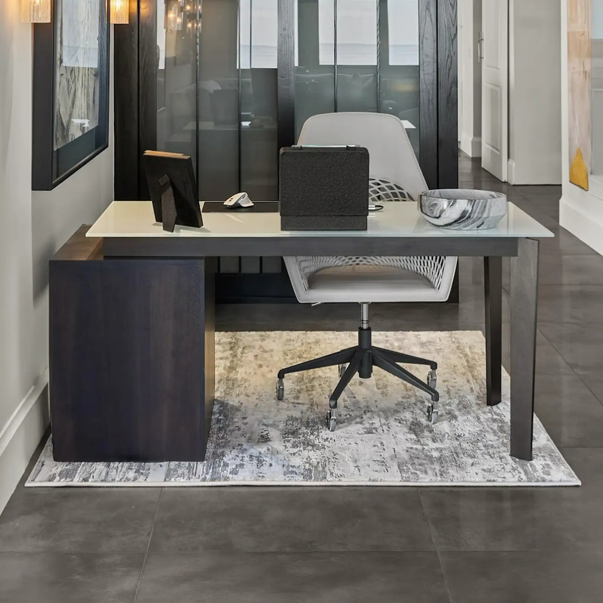 Office desk with ergonomic white chair, black desk organizer, and marble tray in a contemporary work.