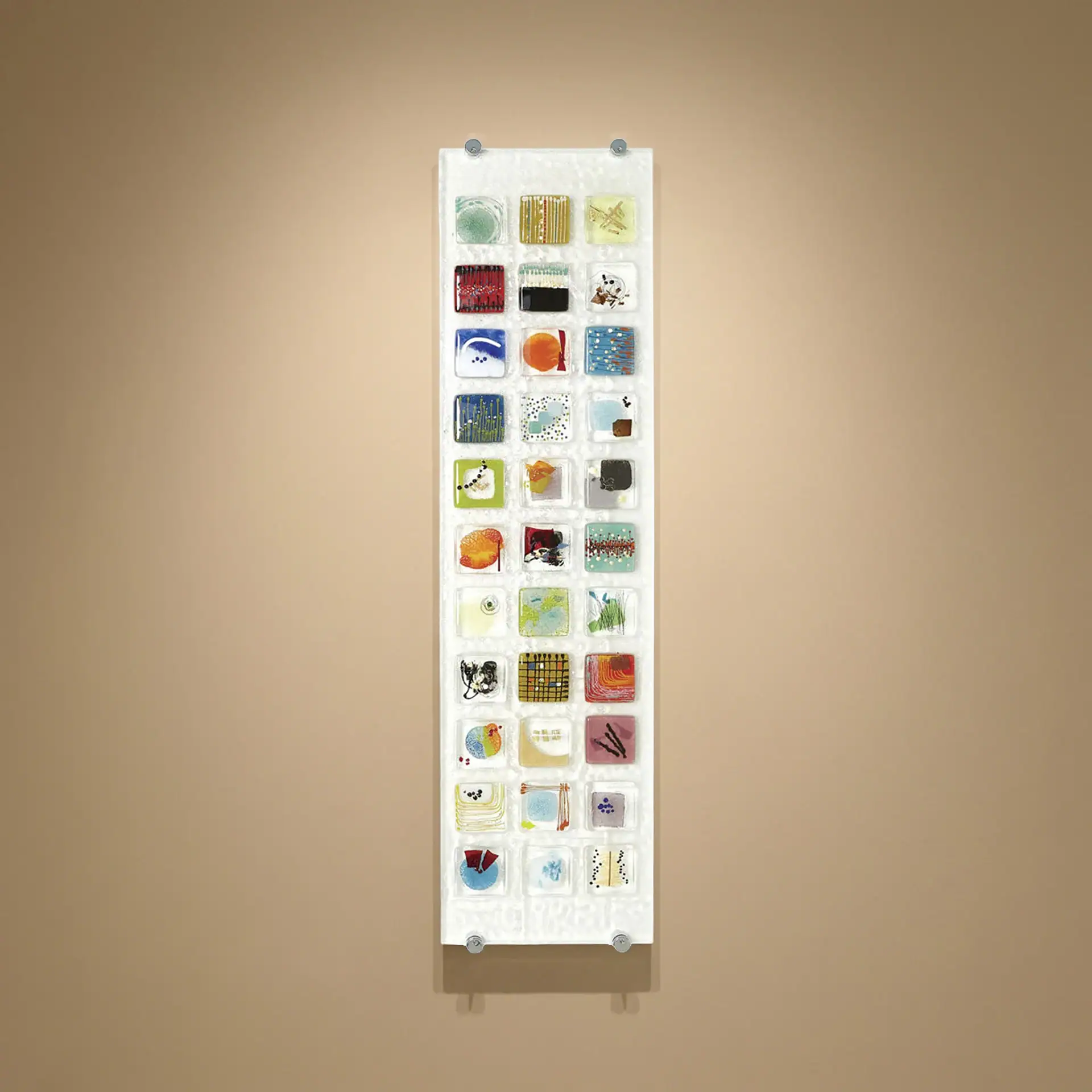 Colorful fused glass wall art piece with various shapes and textures.