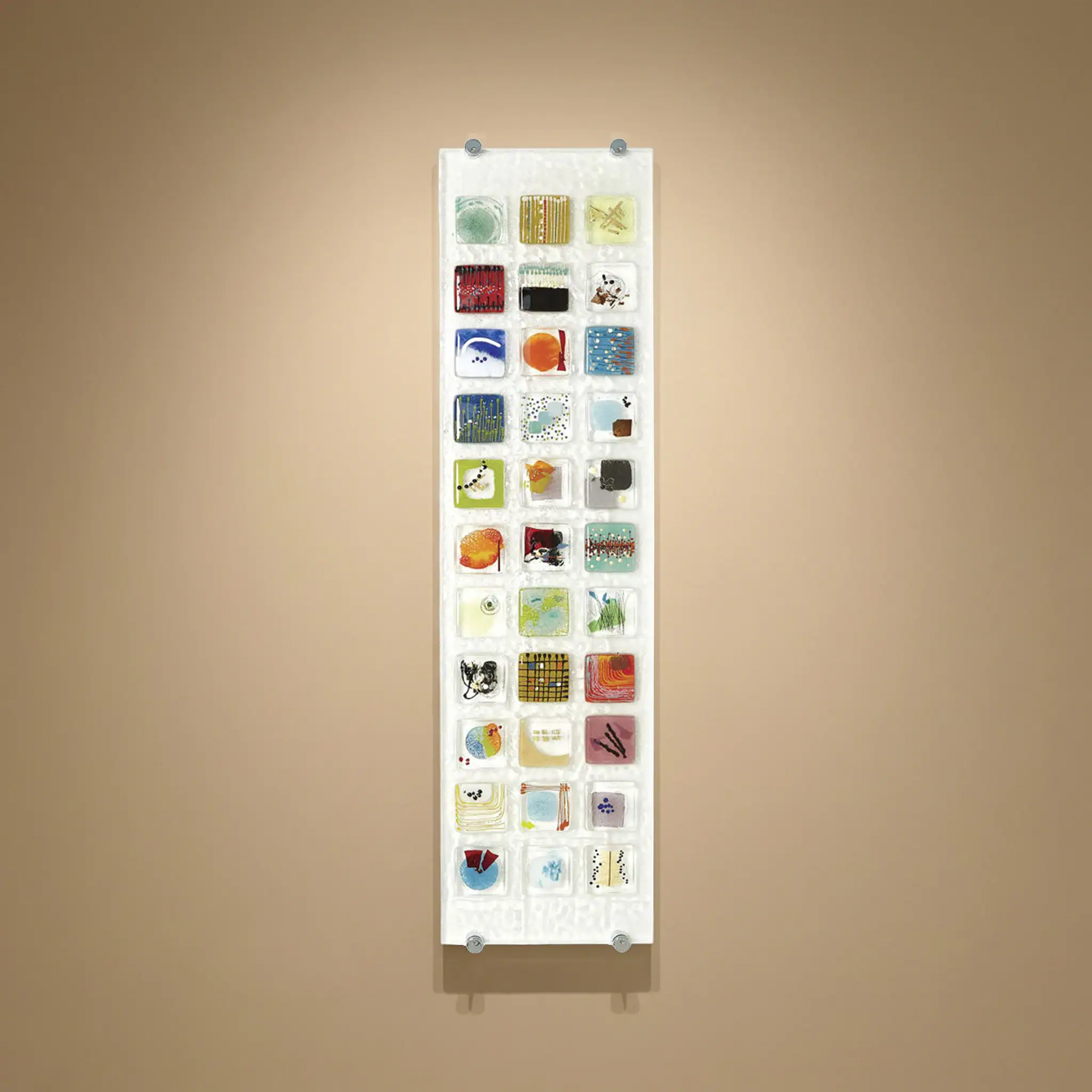 Colorful fused glass wall art piece with various shapes and textures.
