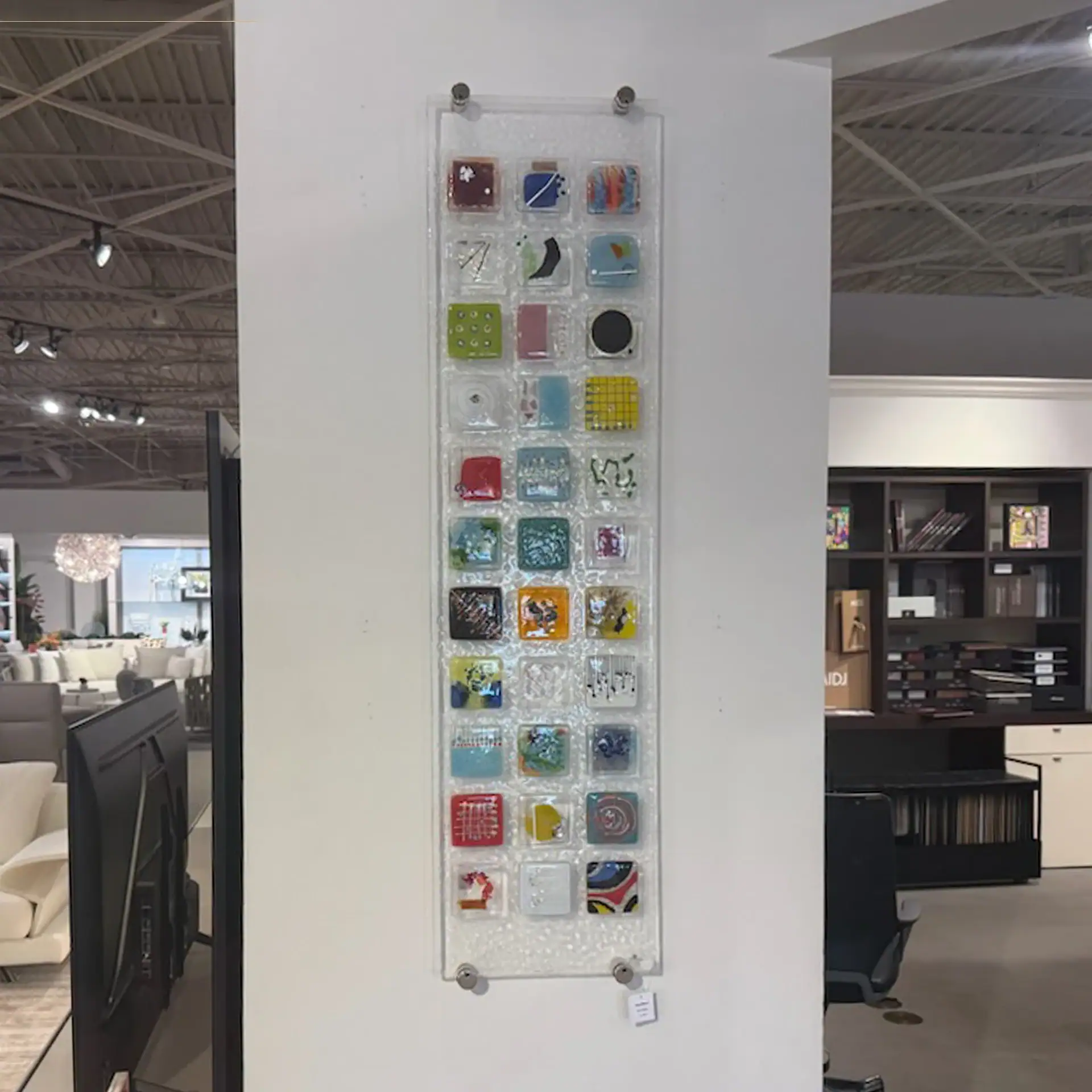 Colorful fused glass wall art panel with various glass pieces and textures.