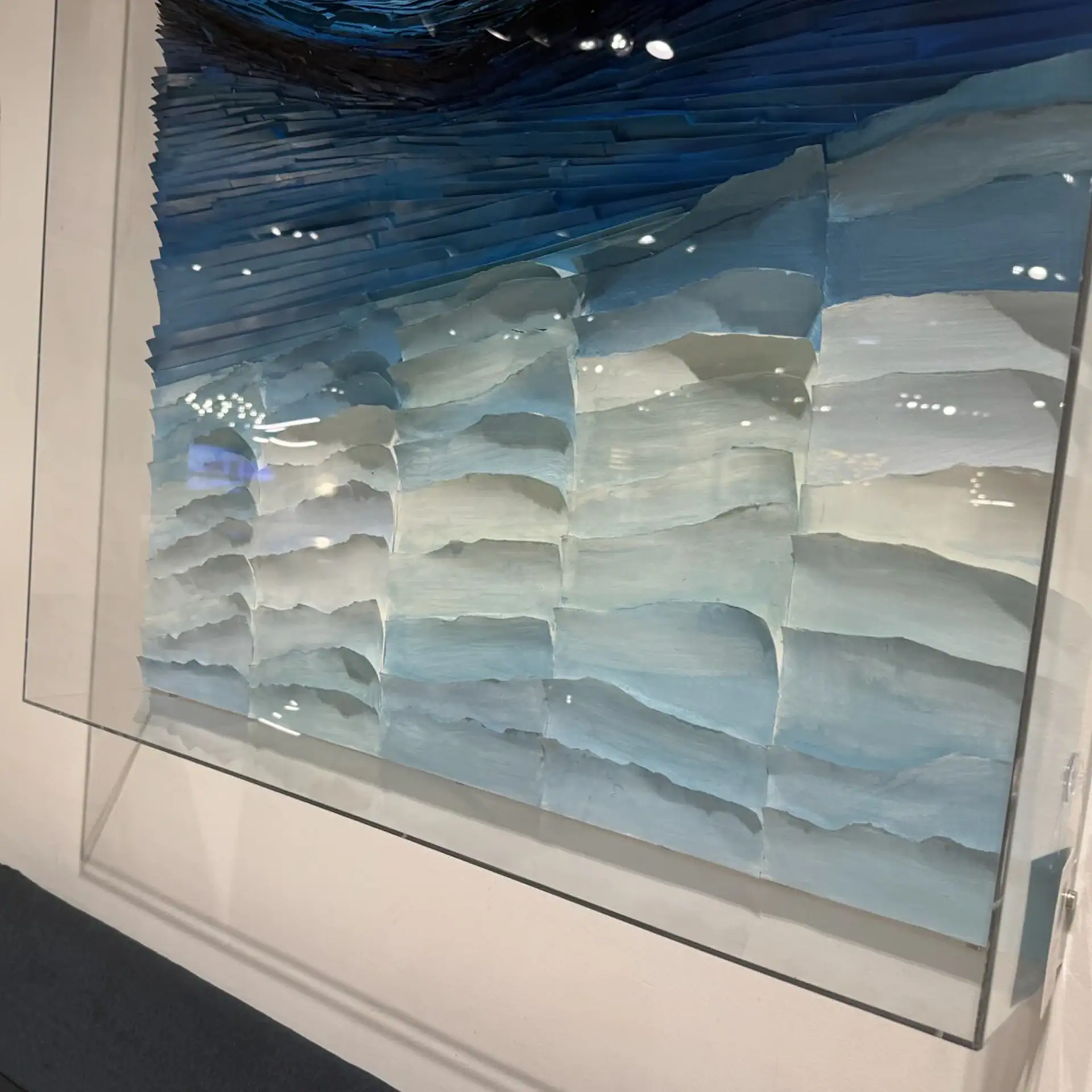 Elegant abstract wall decor featuring layered blue and white textures for contemporary interiors.