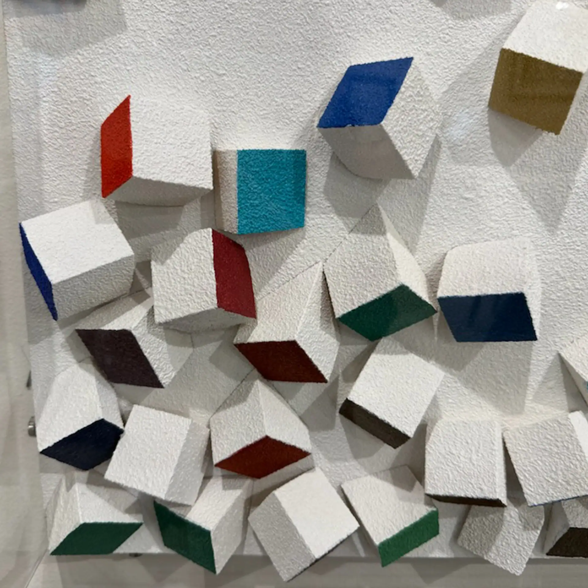 Modern white acoustic wall panels with colorful accents for stylish soundproofing.