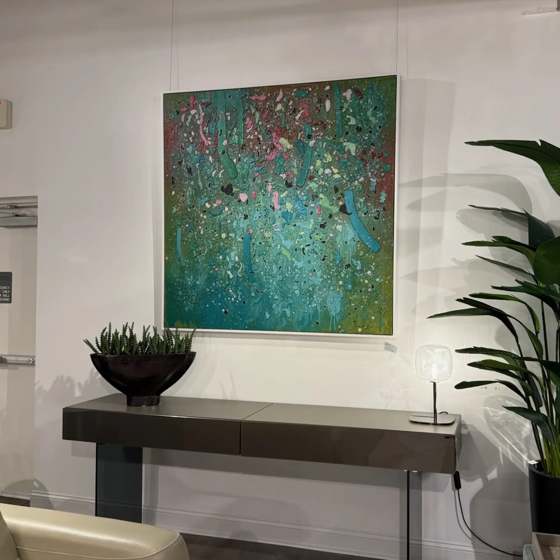 Abstract wall art with vibrant colors in a contemporary office setting.