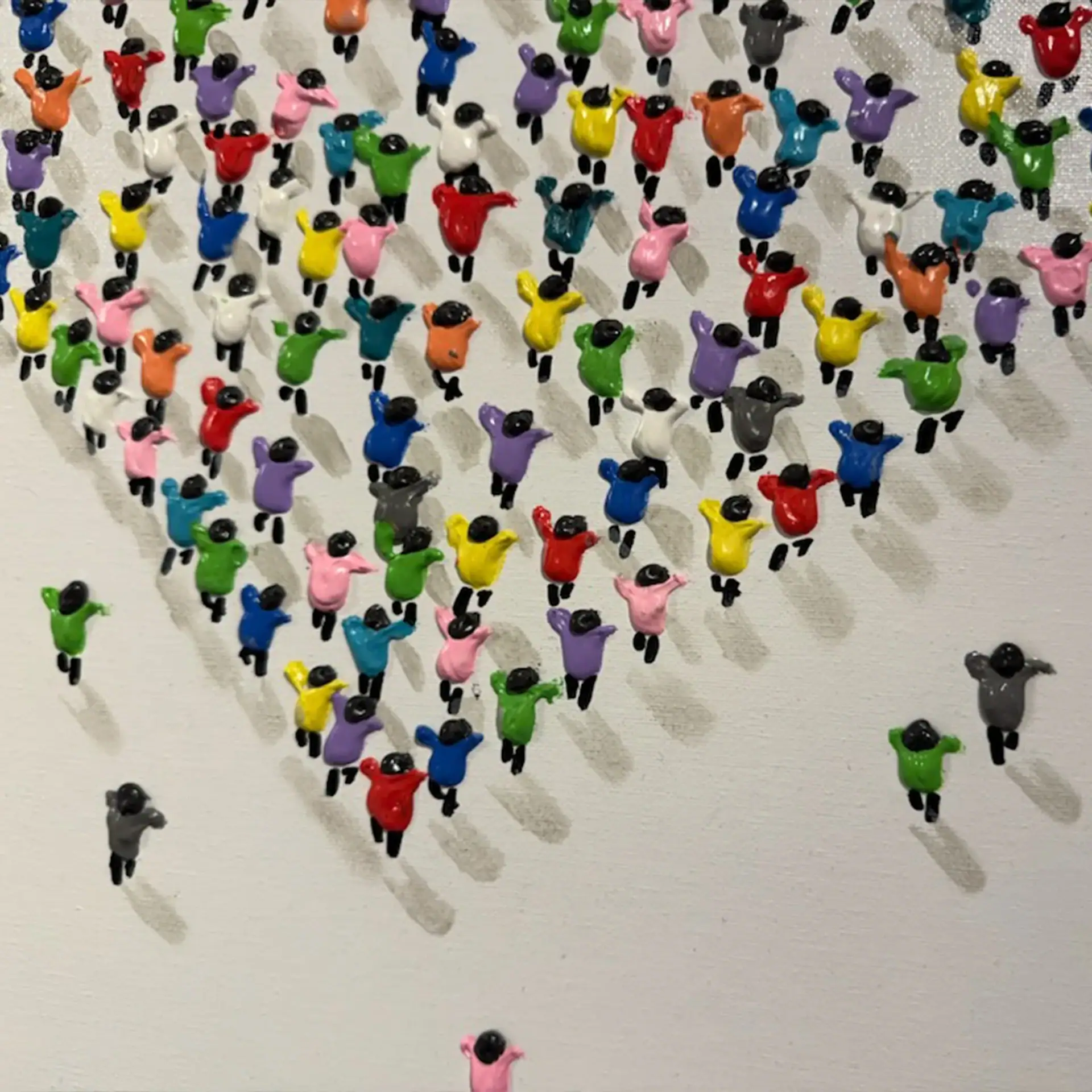 Colorful animal figurines arranged in a heart shape on a white background.