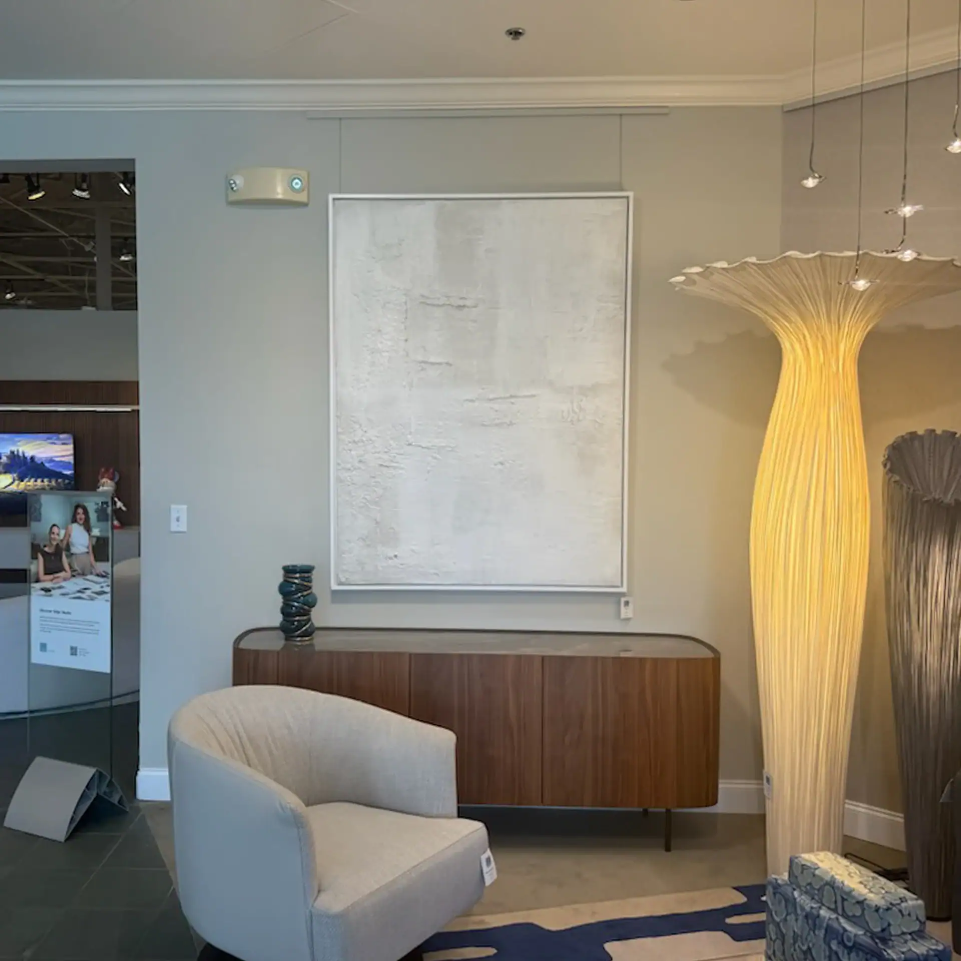 Modern interior with abstract art and unique lighting fixtures.