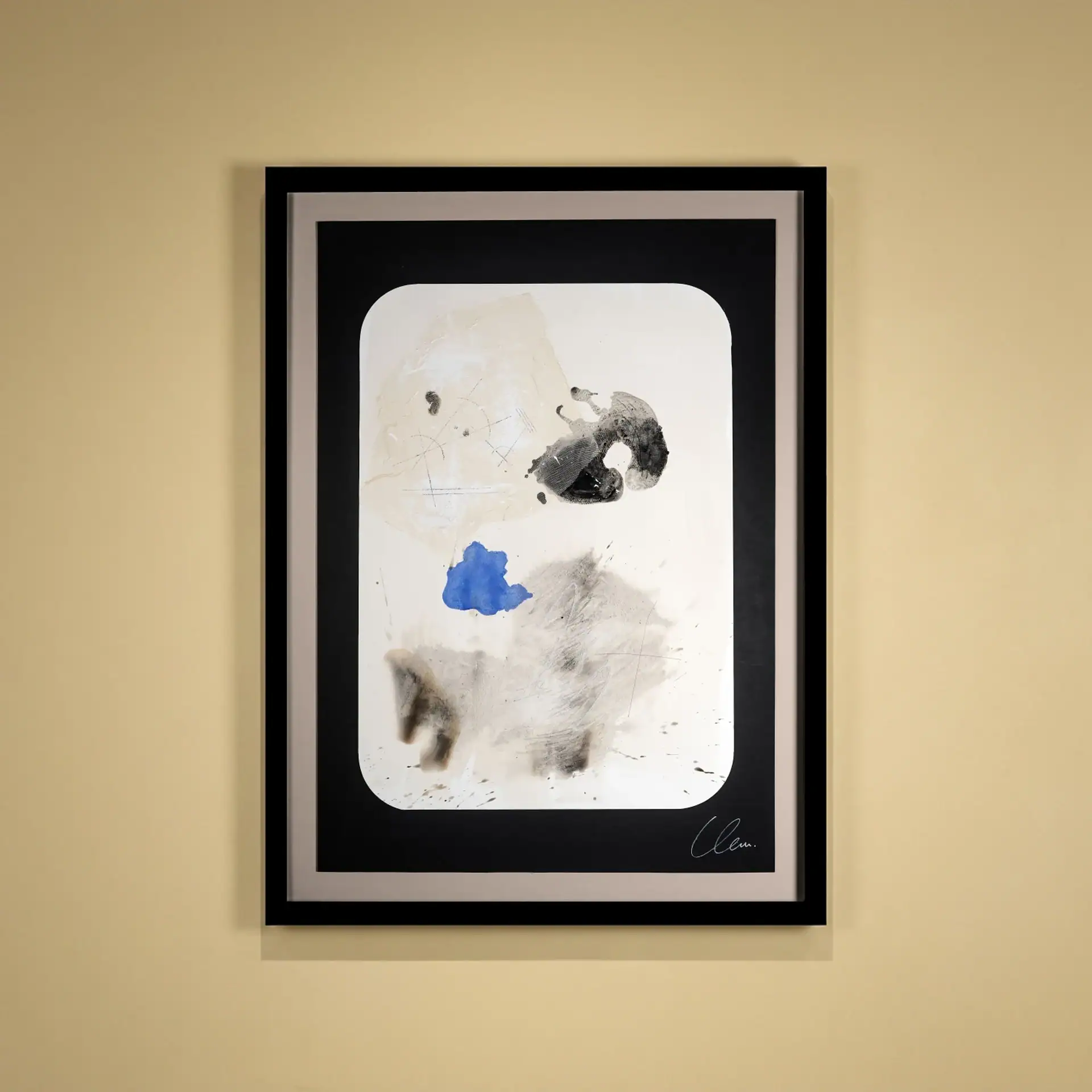 Abstract paper art with black, white, and blue elements in a black frame.