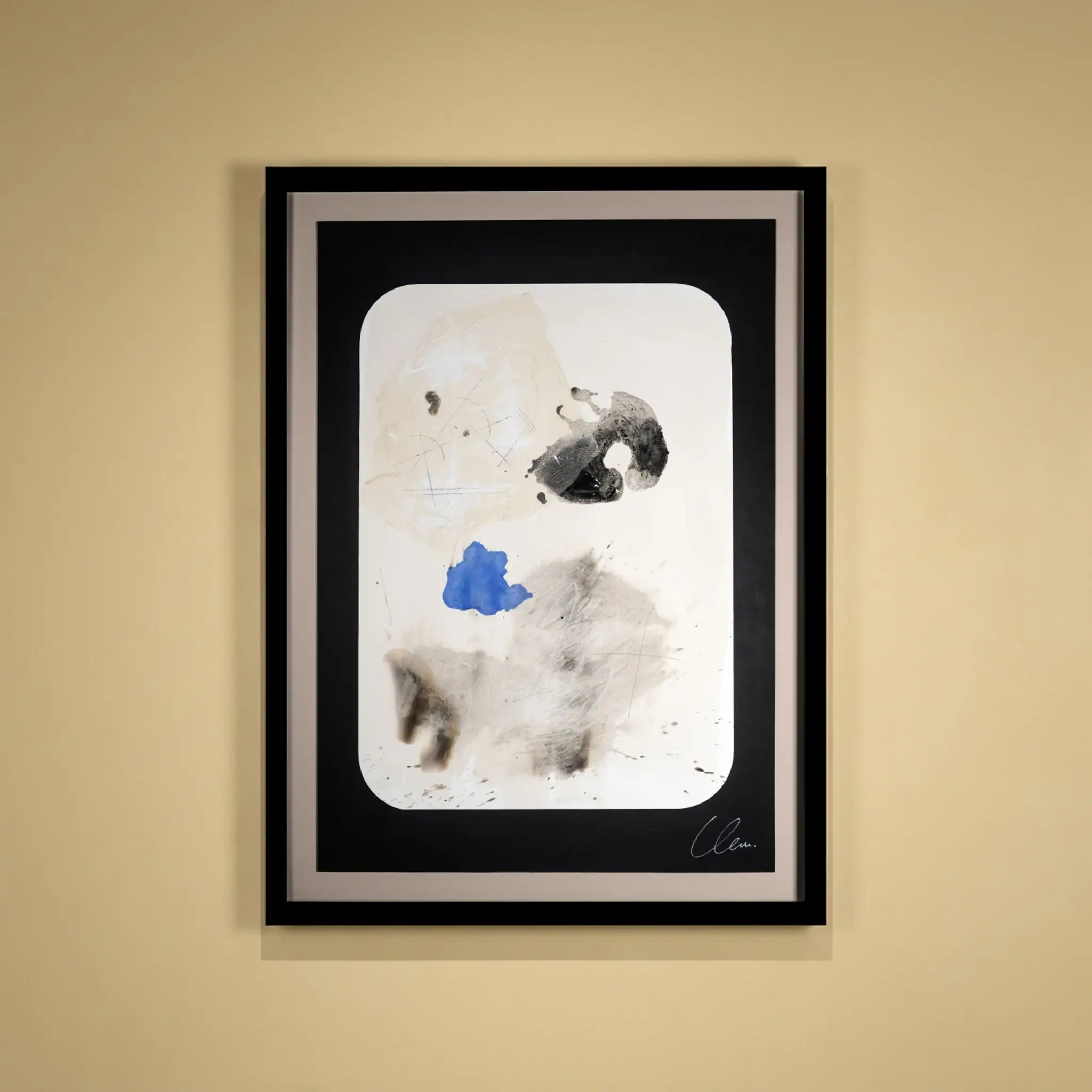Abstract paper art with black, white, and blue elements in a black frame.