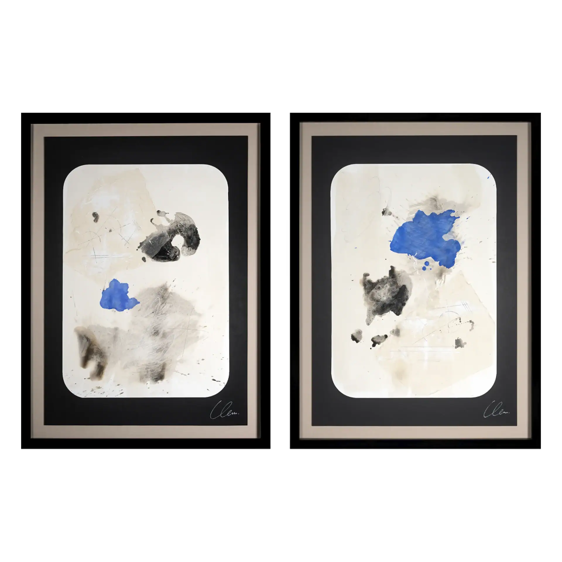 Abstract paper paintings with black, white, and blue ink splashes in black frames.