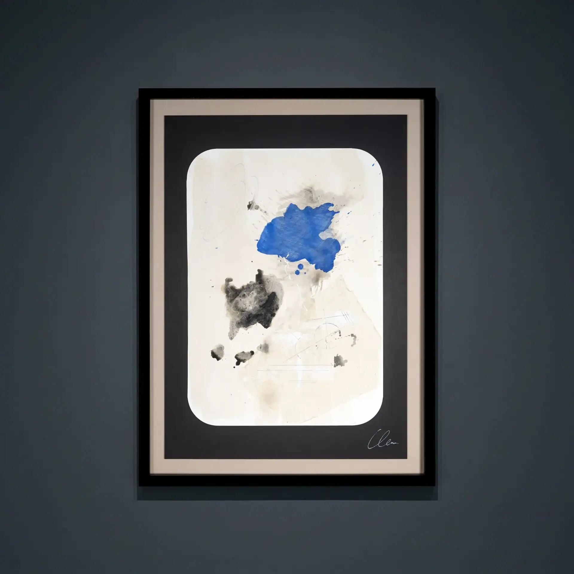 Abstract paper painting with blue and black ink splashes in a frame.