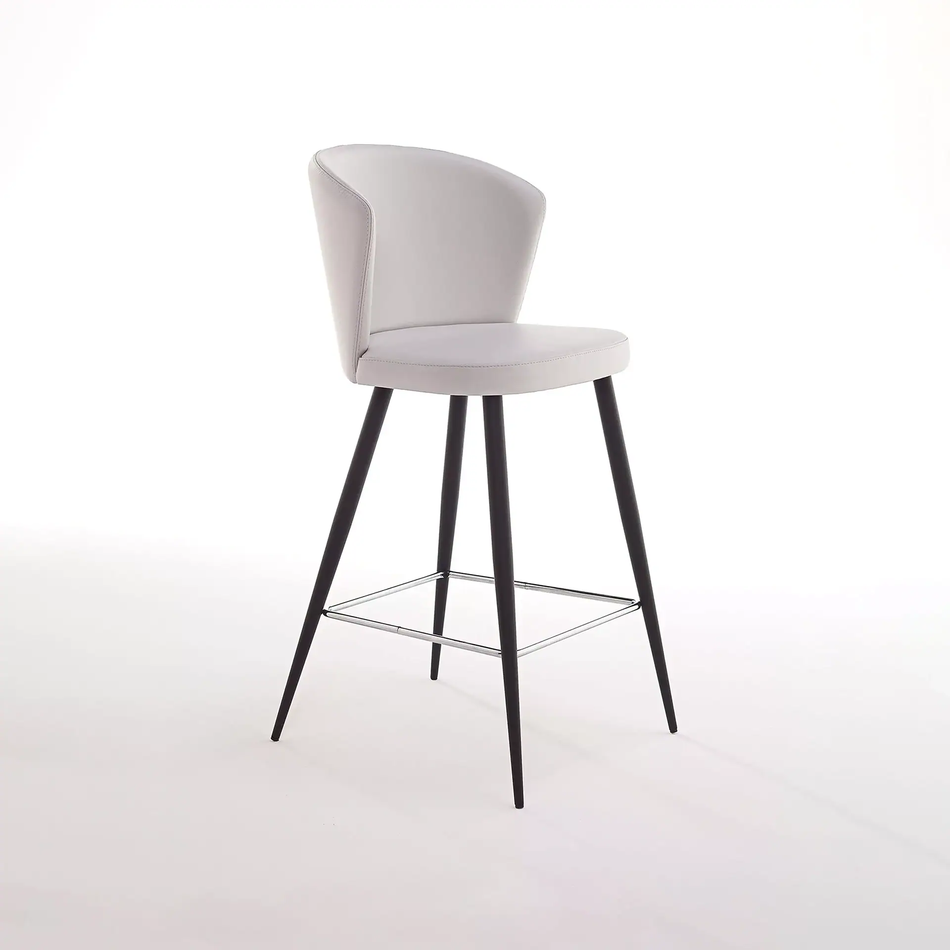 Ines adjustable bar stool with white seat and black legs in a modern setting.
