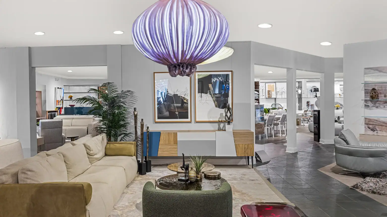 Stylish living room featuring contemporary furniture, a statement pendant light, and tasteful decor.