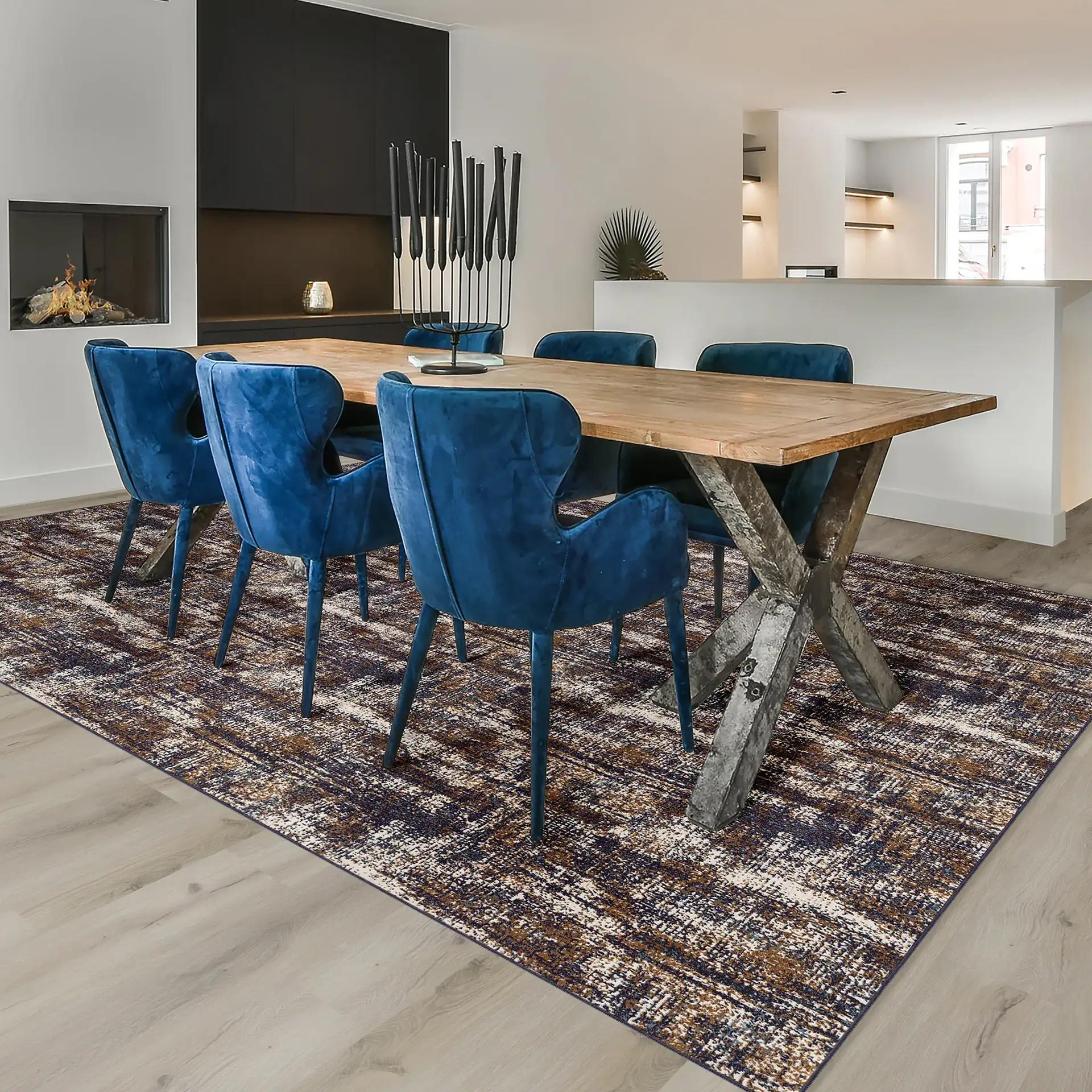 Modern rustic dining table with blue velvet chairs for contemporary home decor.