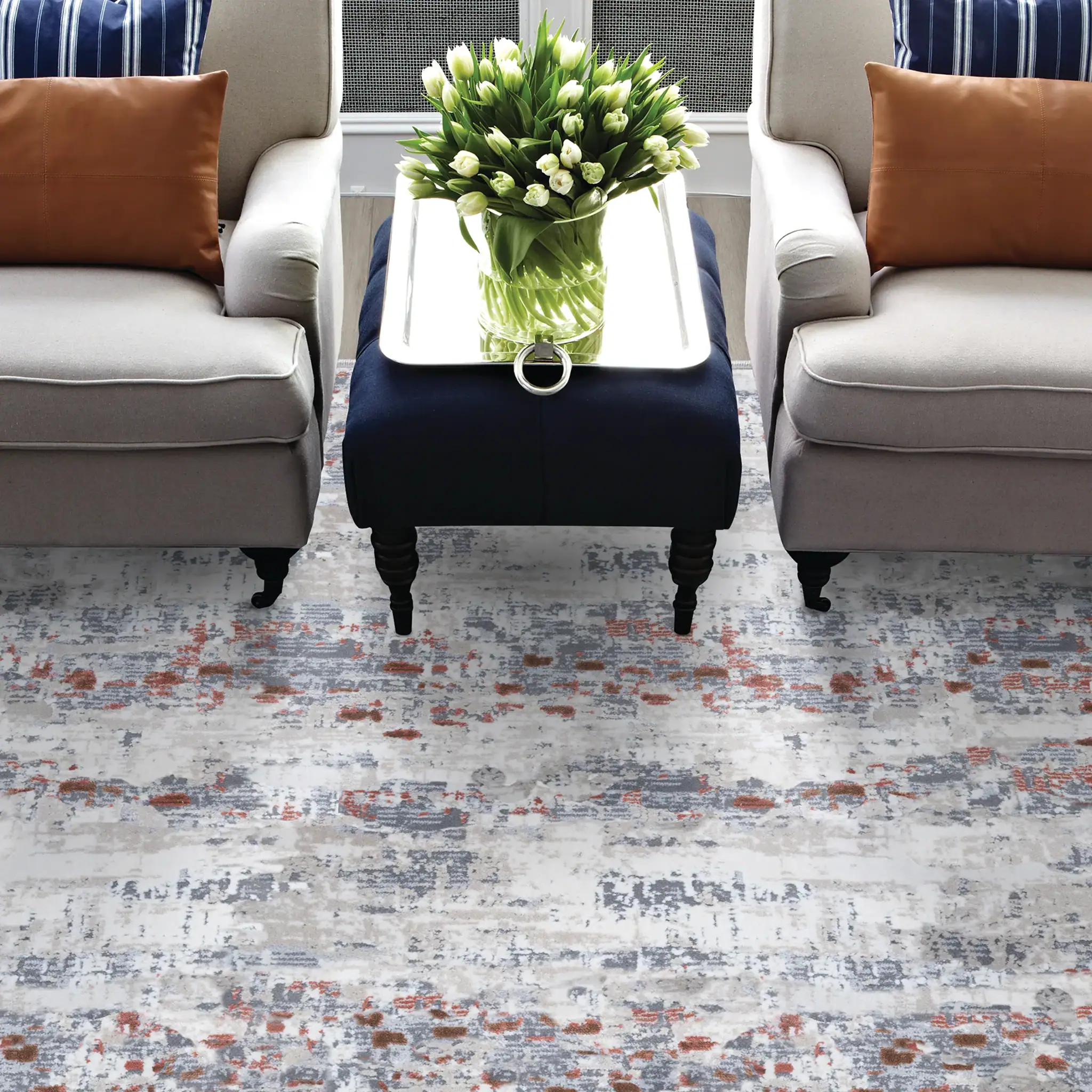 Living room with floral arrangement, sofas, and modern decor.