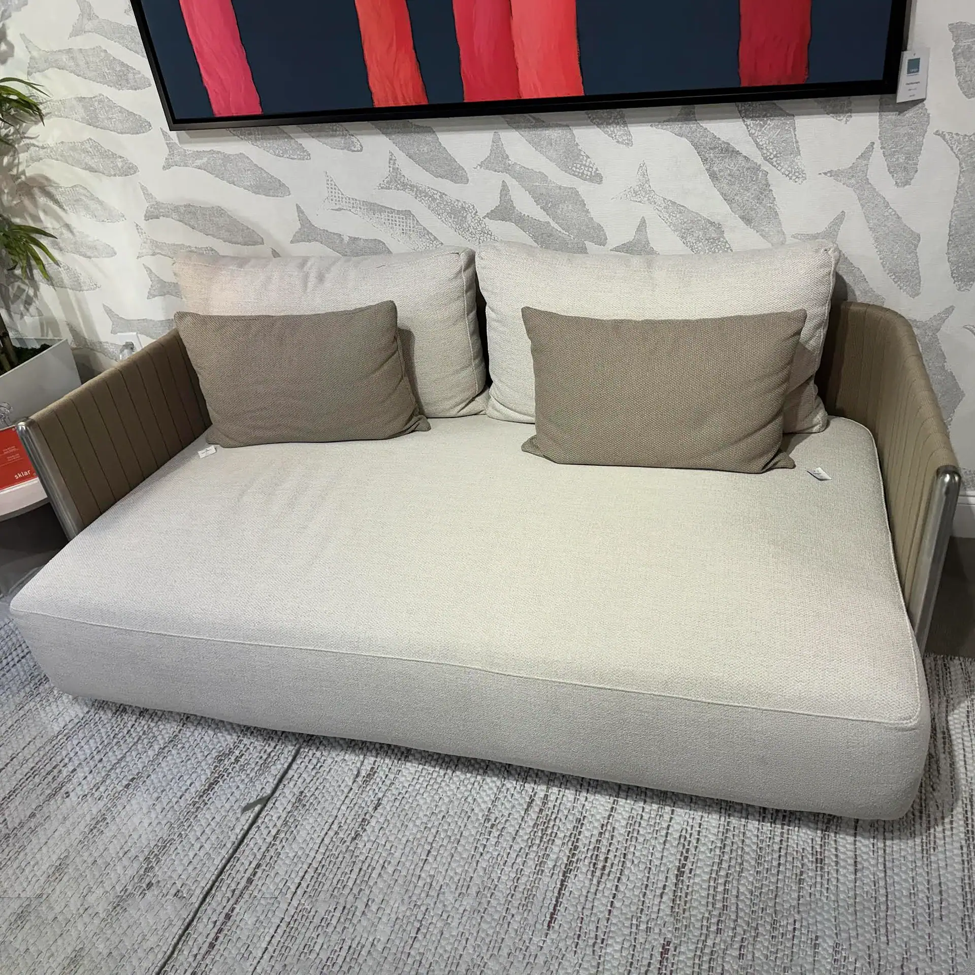 Beige sofa with wooden armrests and cushions, ideal for contemporary living room decor.