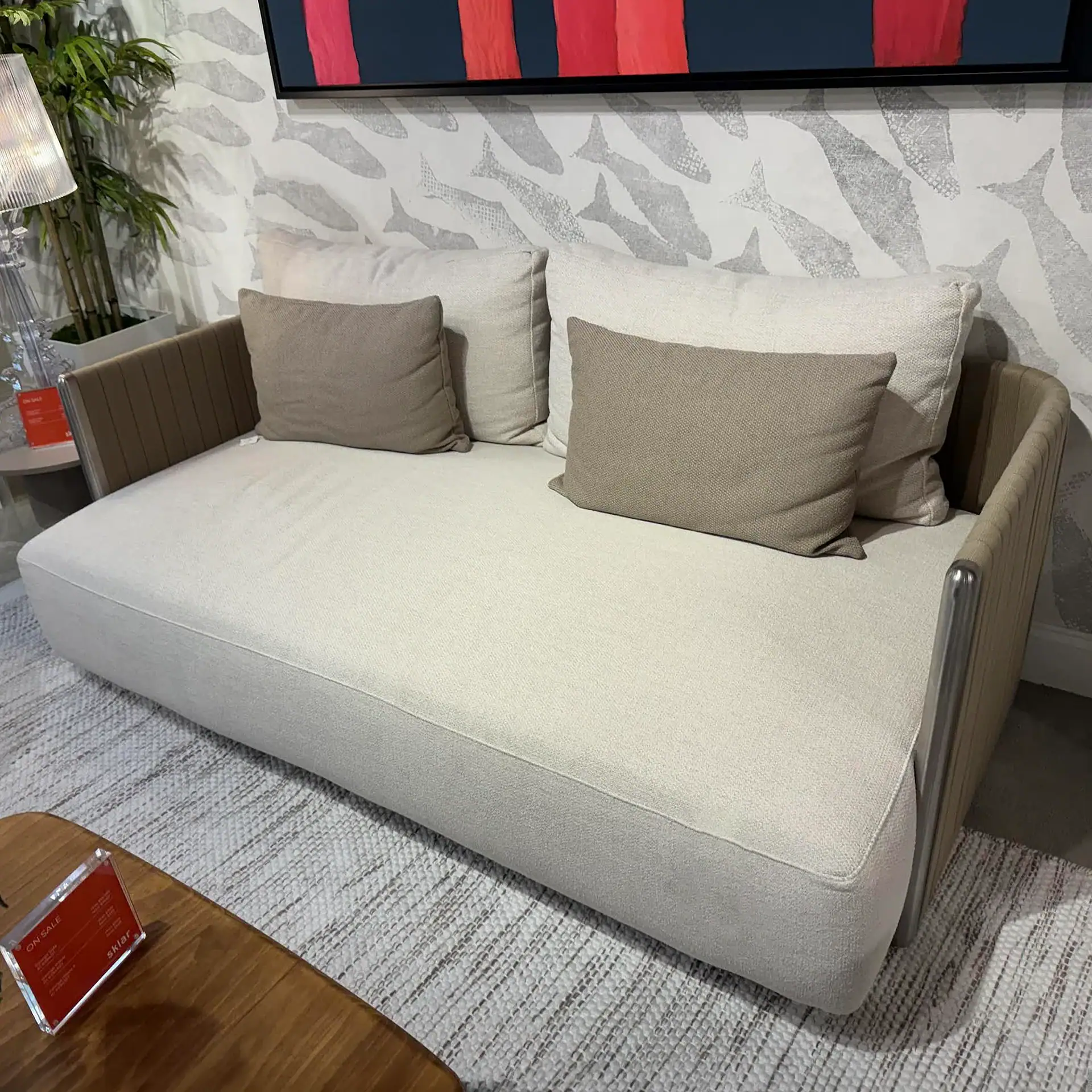 Modern beige sofa with cushions, ideal for contemporary living room decor.