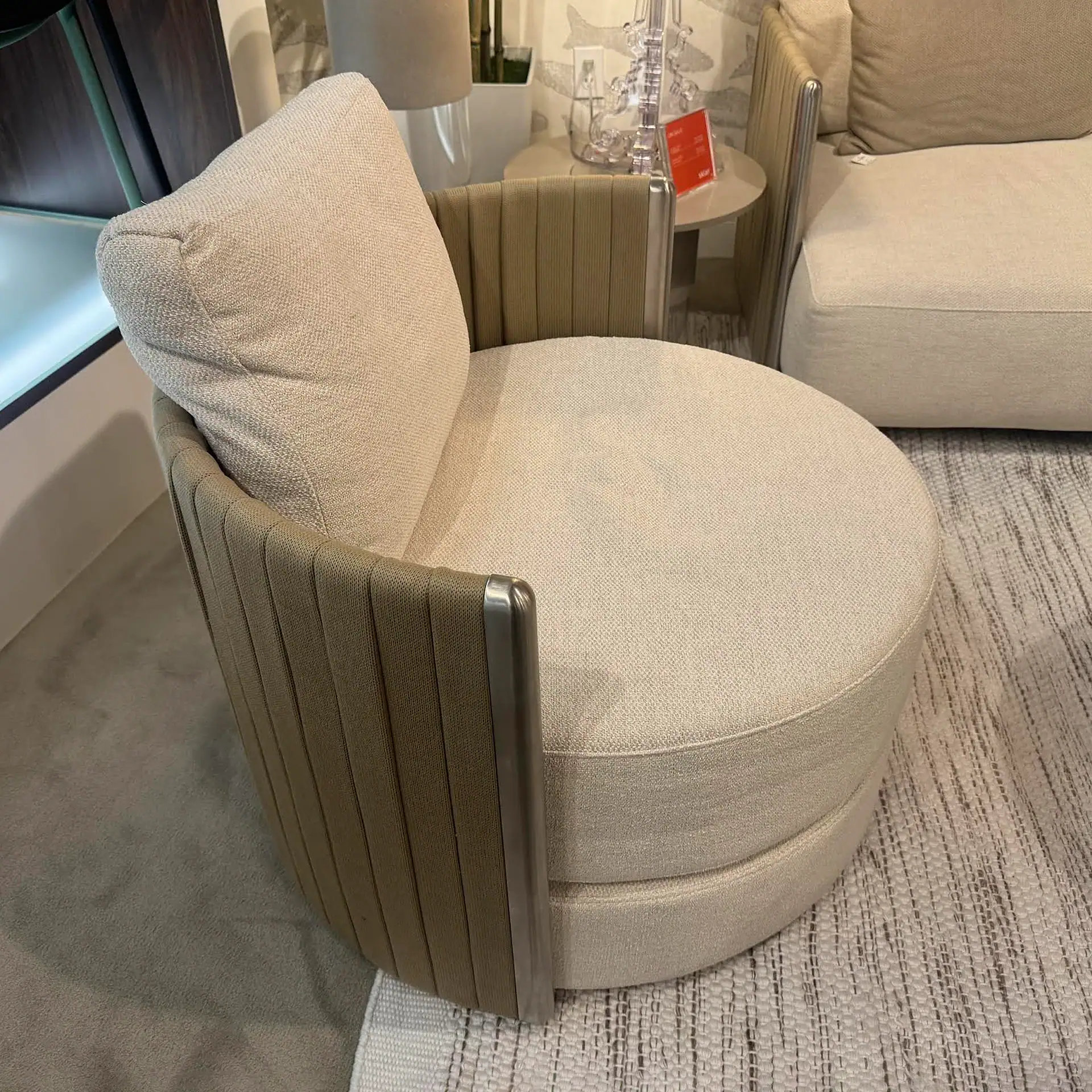 Beige and metallic accent armchair with plush cushion, ideal for modern living room decor.