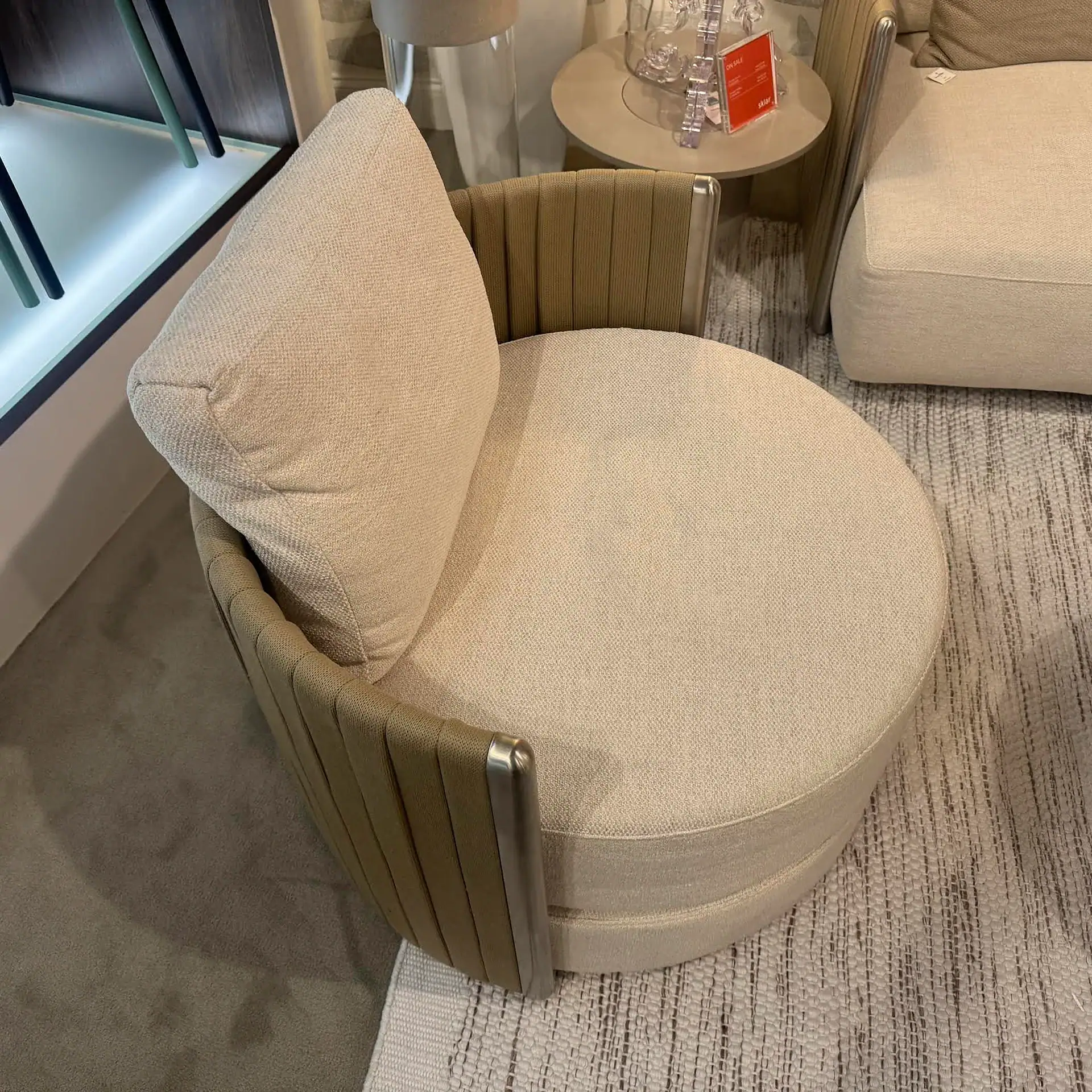 Stylish beige accent chair with curved back and plush cushion, perfect for modern living rooms.