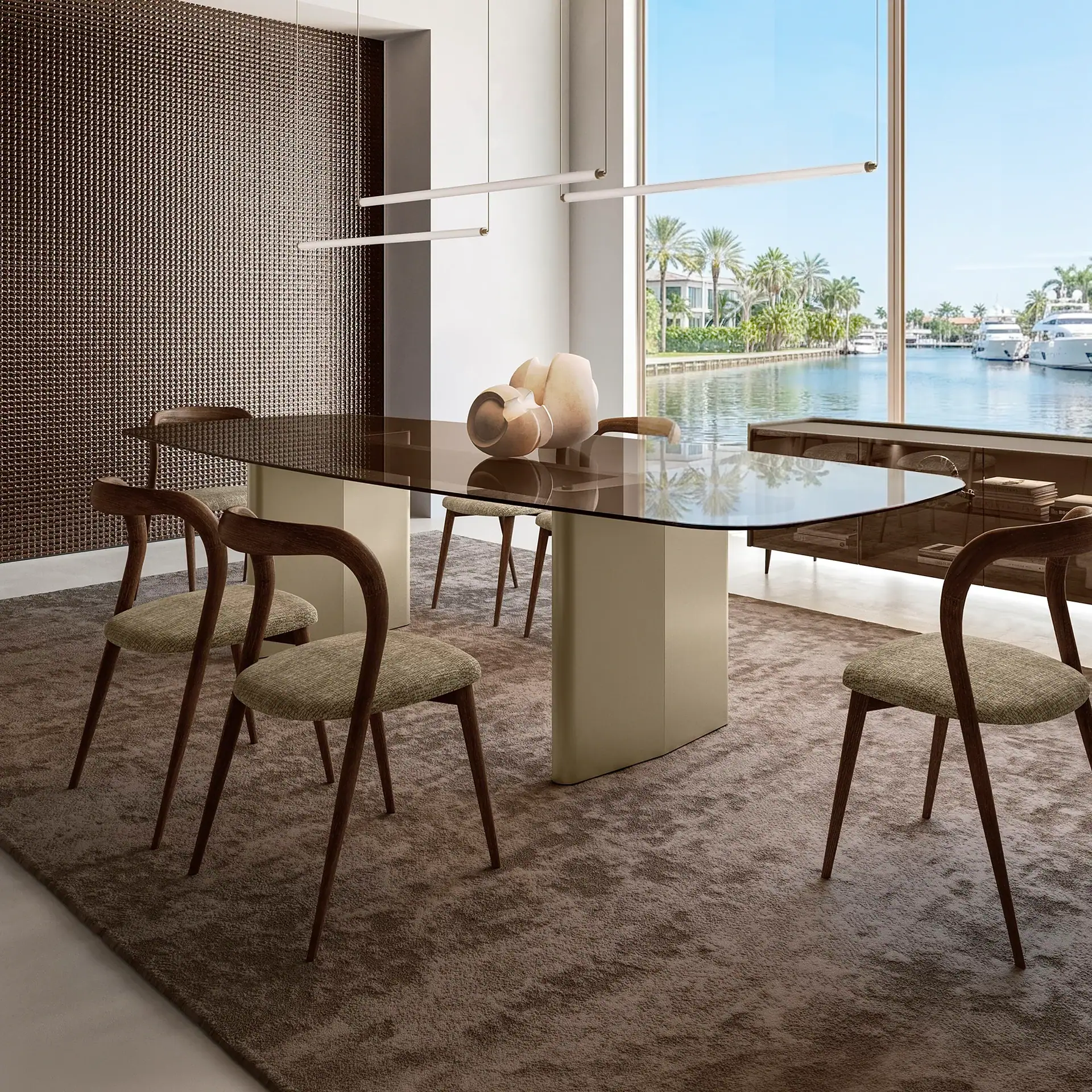 Modern dining table with wooden chairs and a glass top near a window with water view.