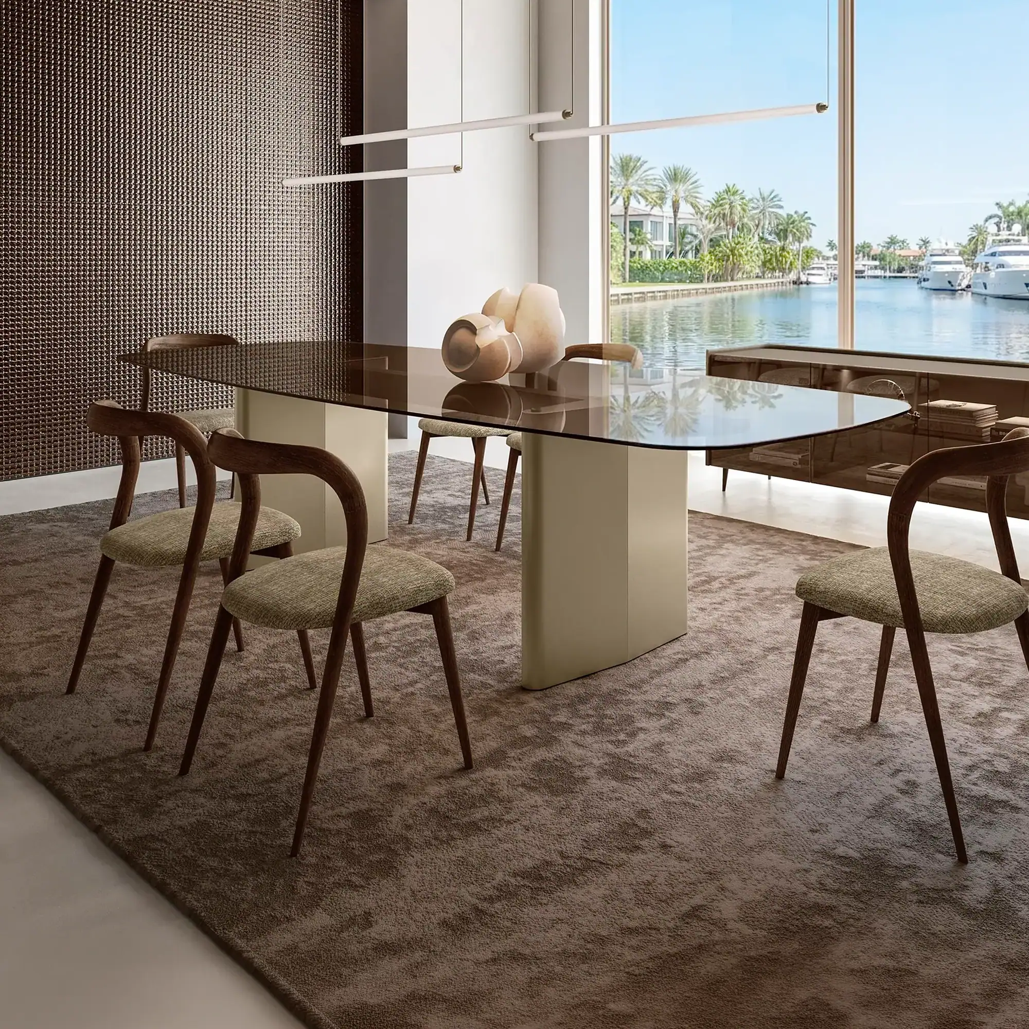 Sklar Furnishings Nuvolari Dining Table in a modern dining room with large windows.