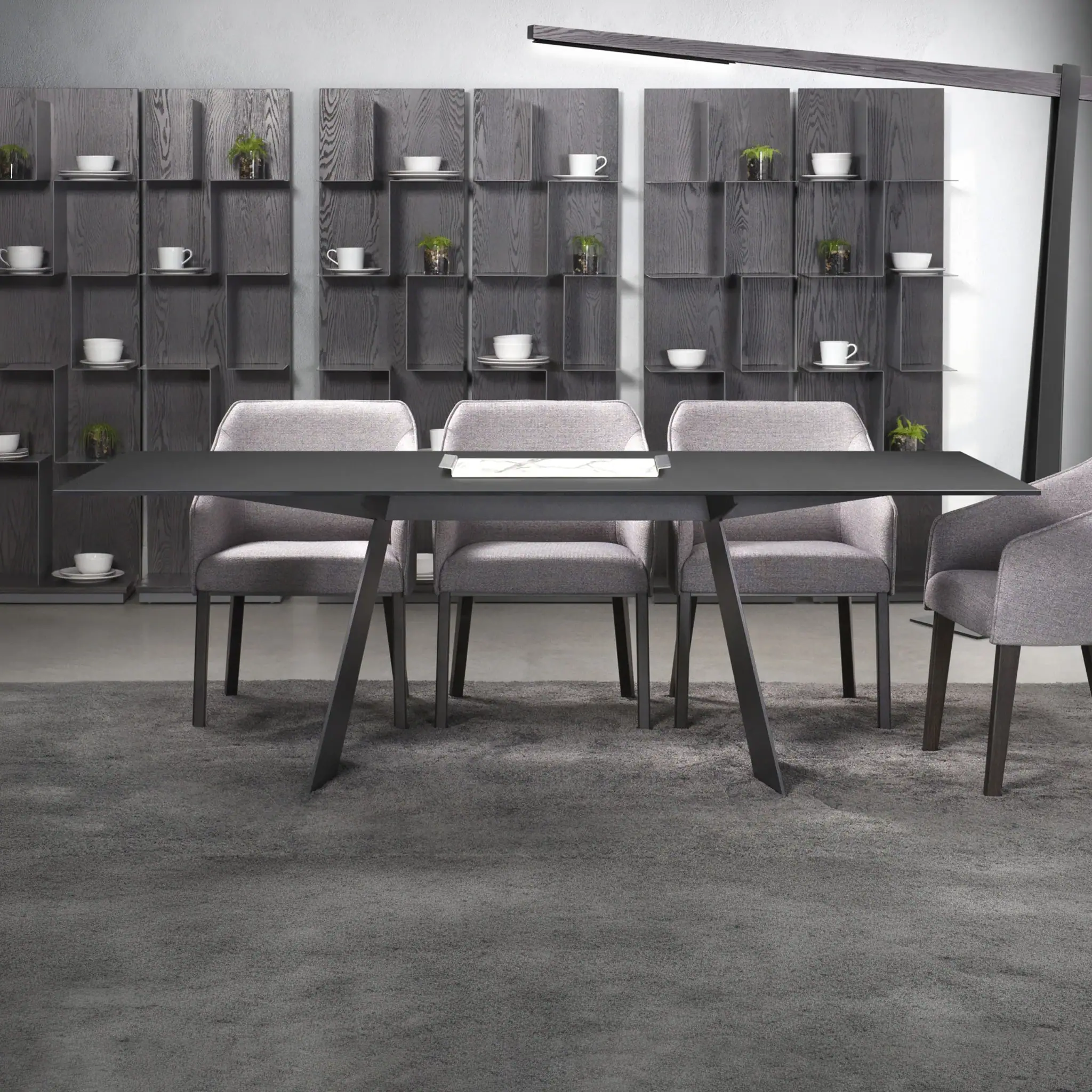 Contemporary gray dining table with matching chairs in a sleek, modern setting.