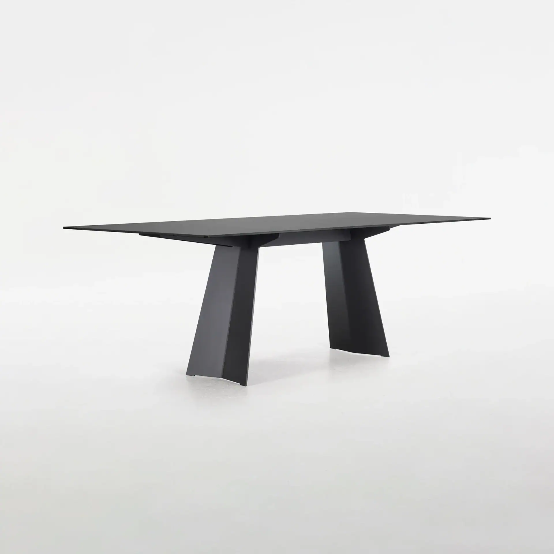 Sleek black dining table with minimalist design, perfect for contemporary interiors.