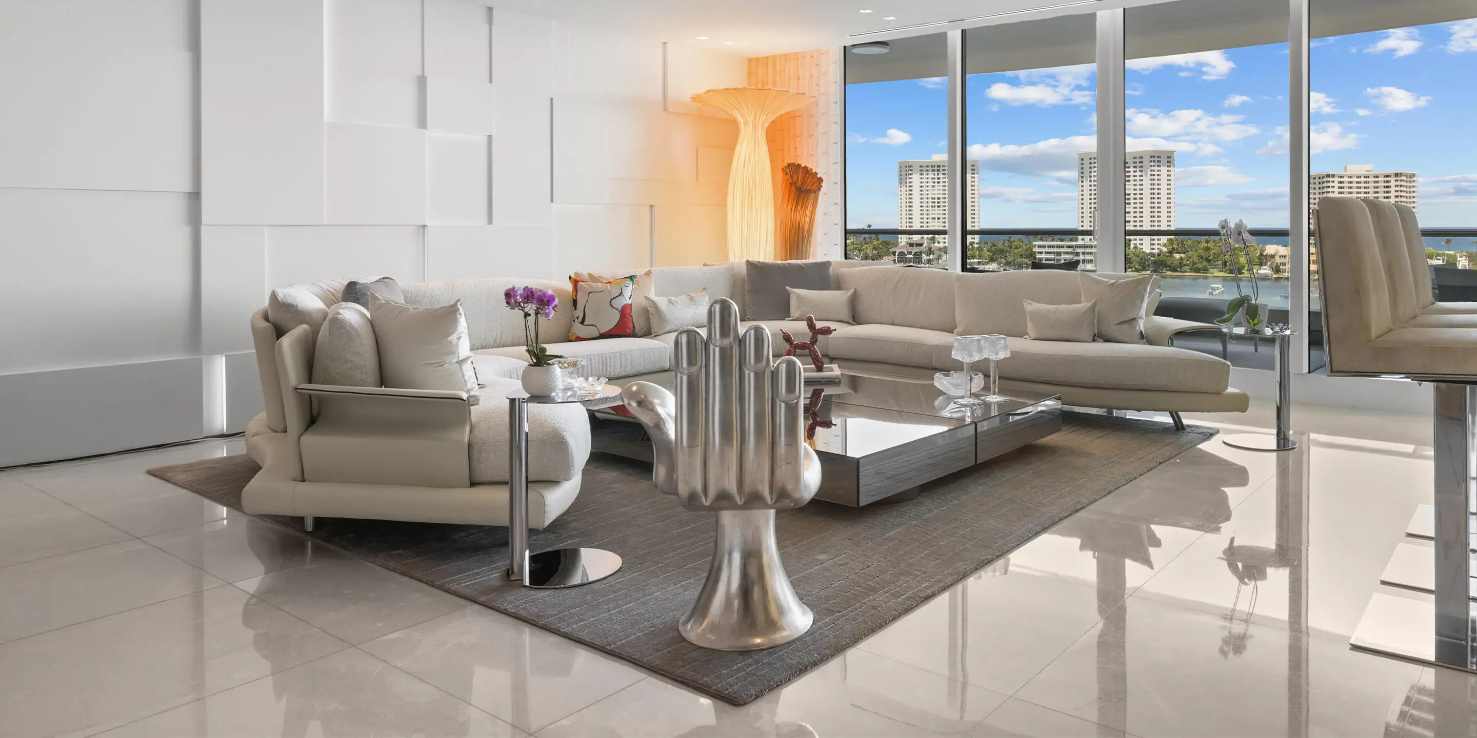 Spacious waterfront living room with large windows and contemporary furniture.