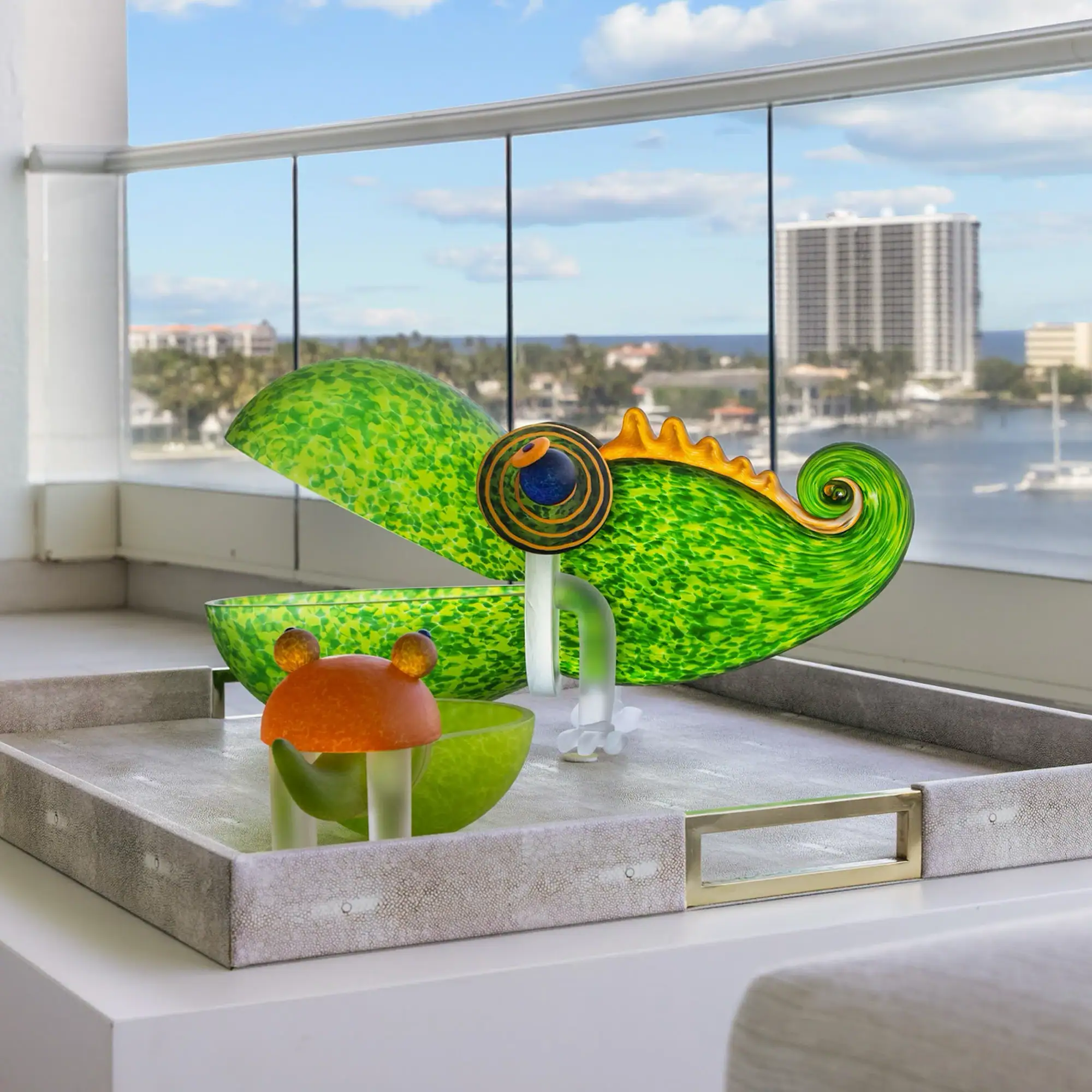 Colorful Glass Chameleon Sculpture Vibrant glass chameleon sculpture with detailed eyes and tail on a windowsill.