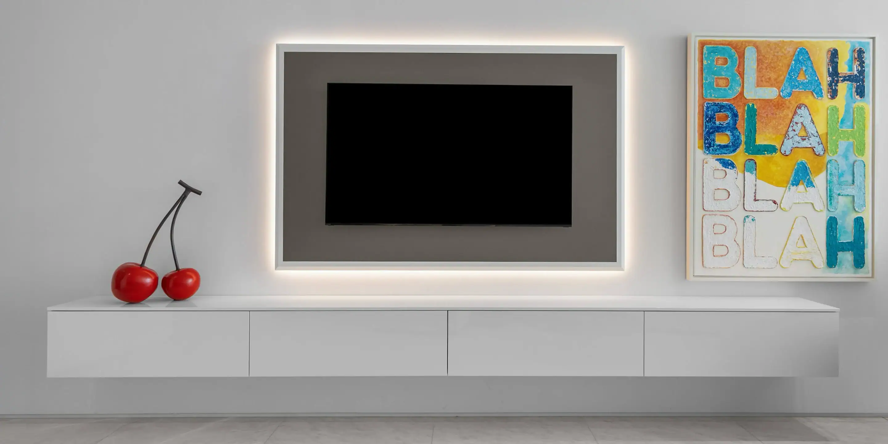 Modern Wall Art and TV Setup Minimalist TV wall with modern art piece and cherries on a white console.