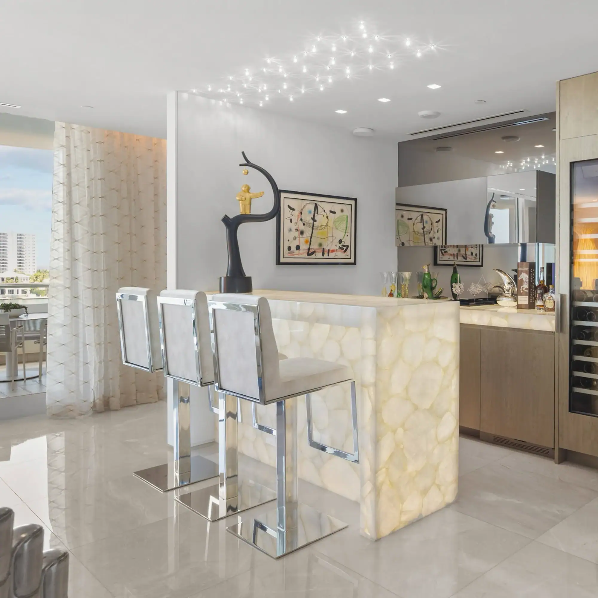 Modern Waterfront Home Interior Contemporary kitchen with bar stools and decorative art.