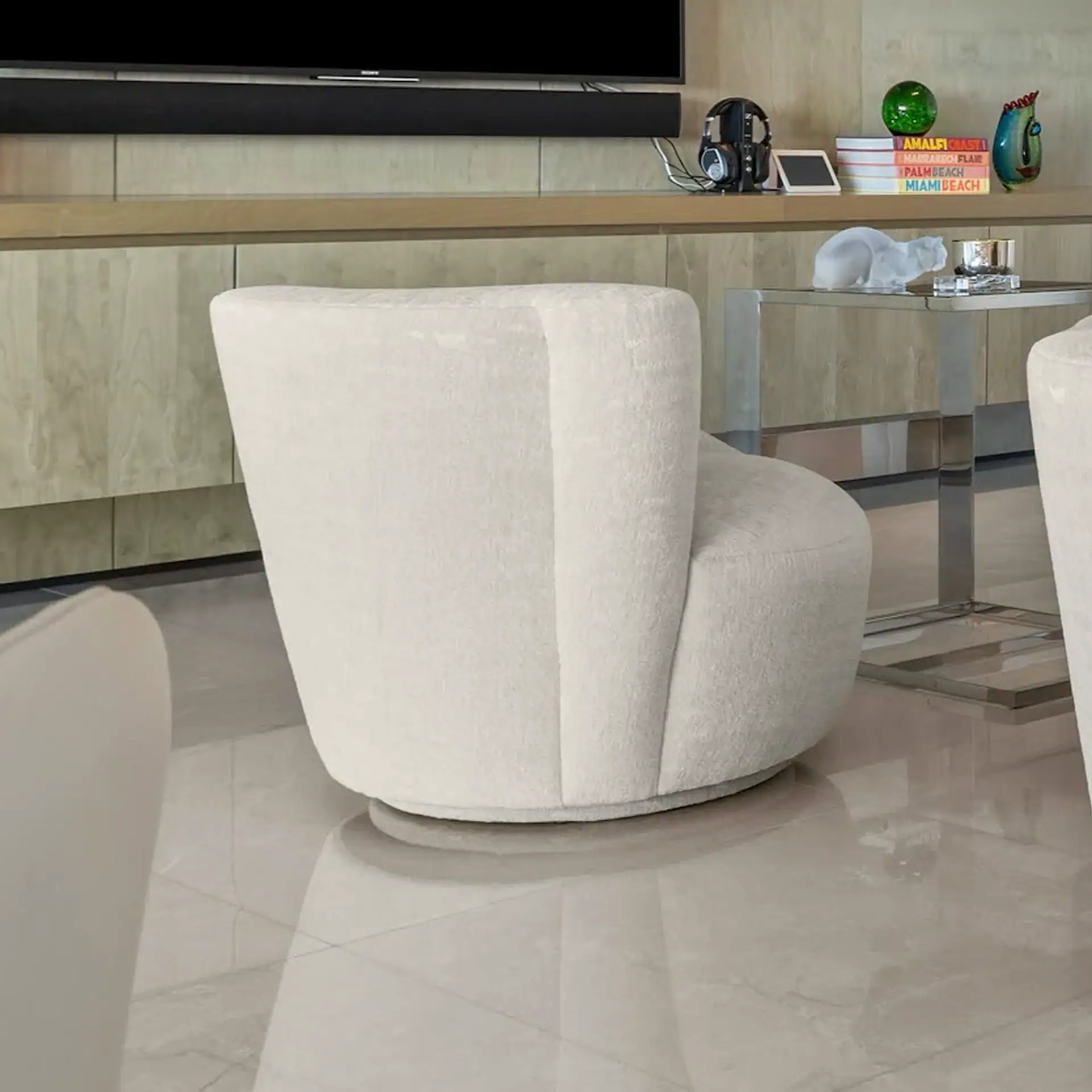 White lounge chair with rounded back in a contemporary living room.