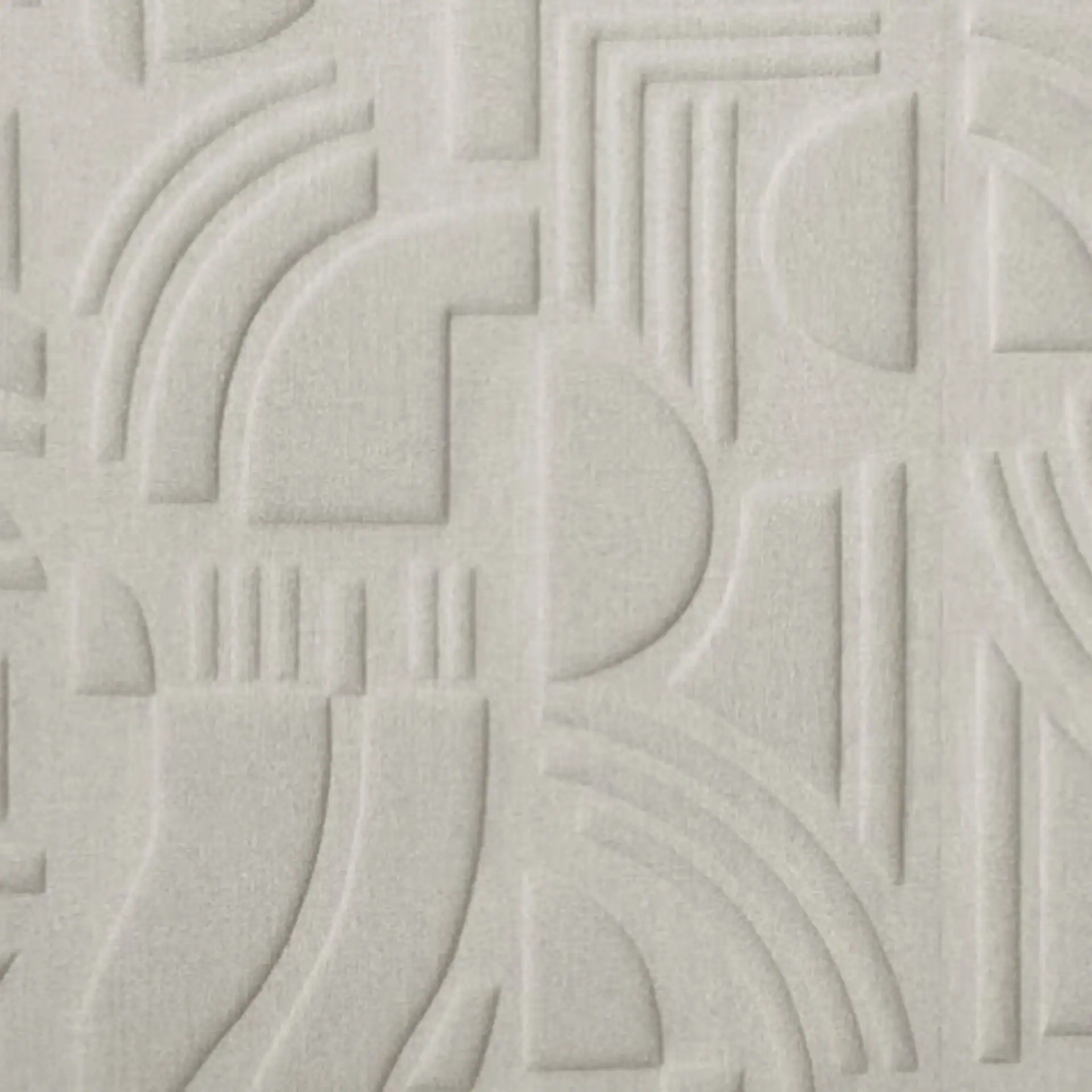 Close-up of textured wall art with geometric patterns in neutral tones.