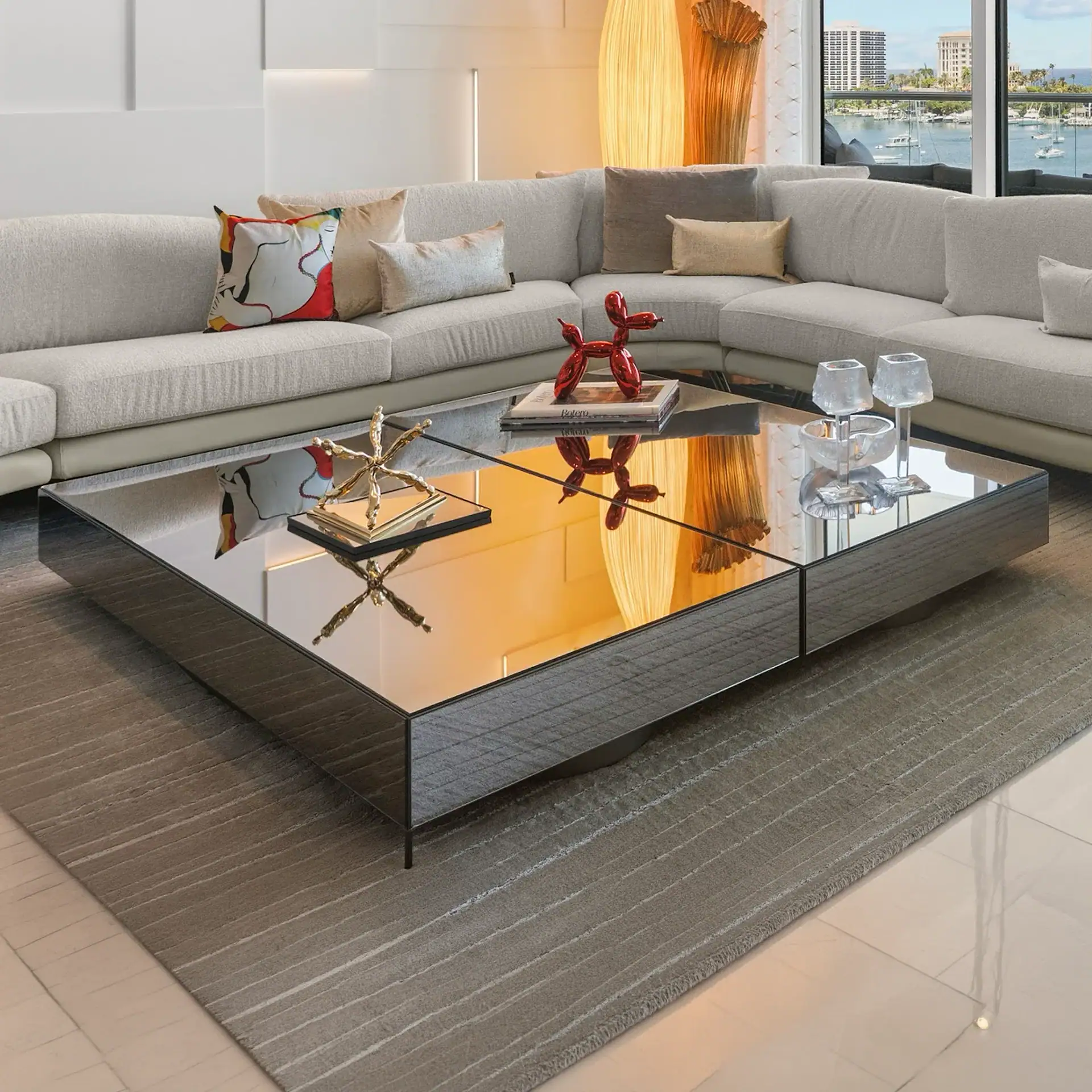 Contemporary living room with a sleek black coffee table and a large sectional sofa.