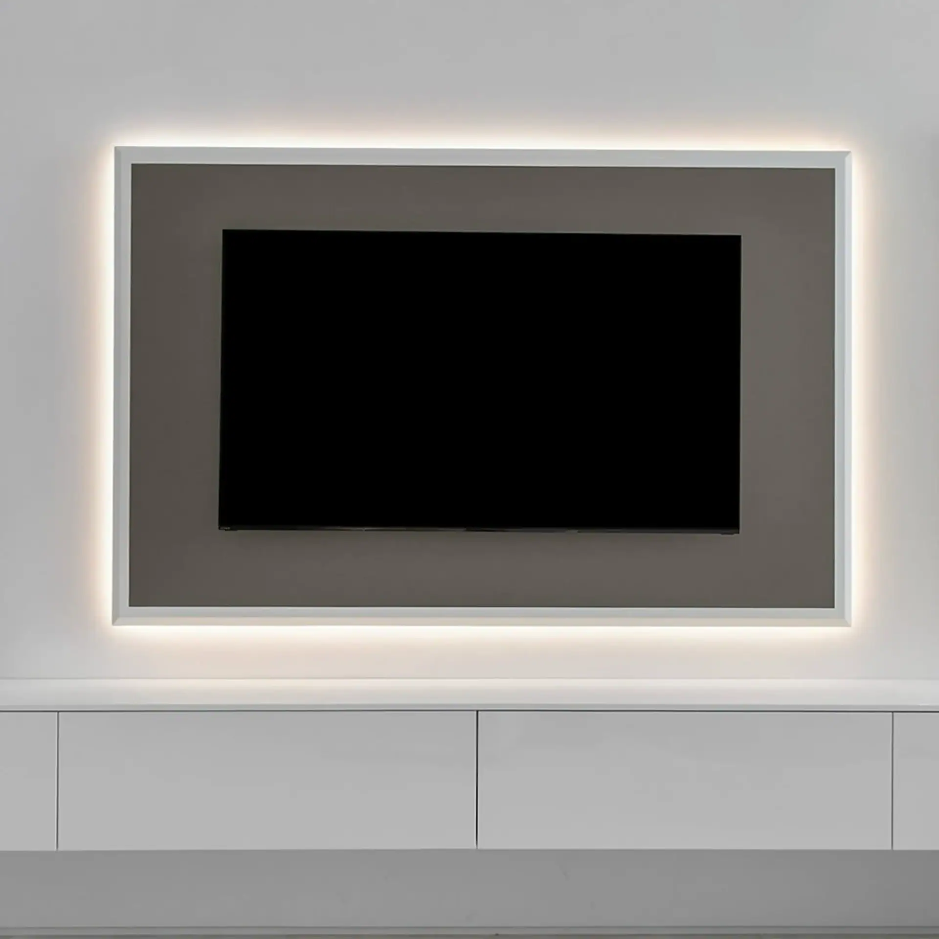 Flat-screen TV mounted on a wall with backlit frame in a minimalist room.