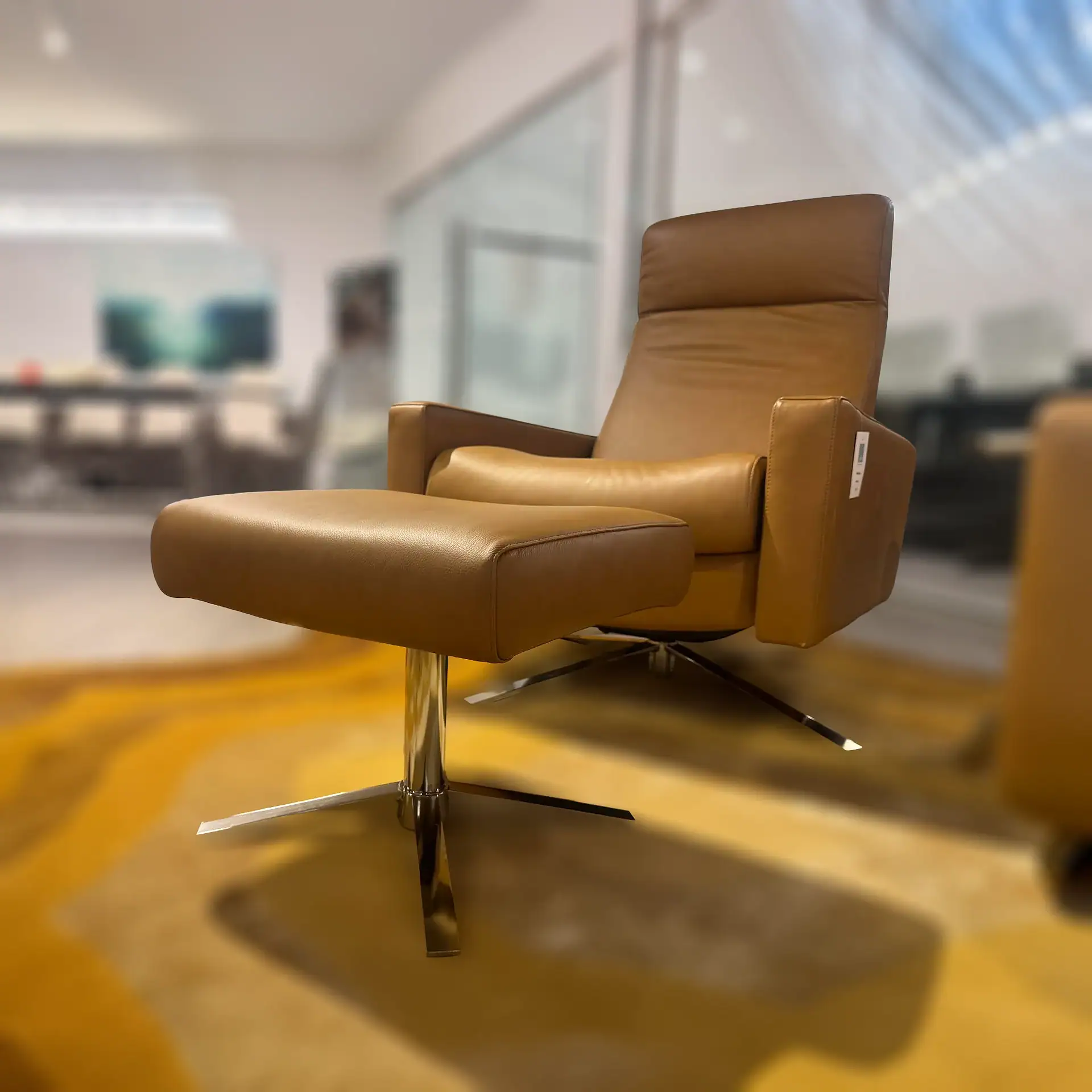 American Leather Cloud XL recliner and ottoman in tan leather in showroom.