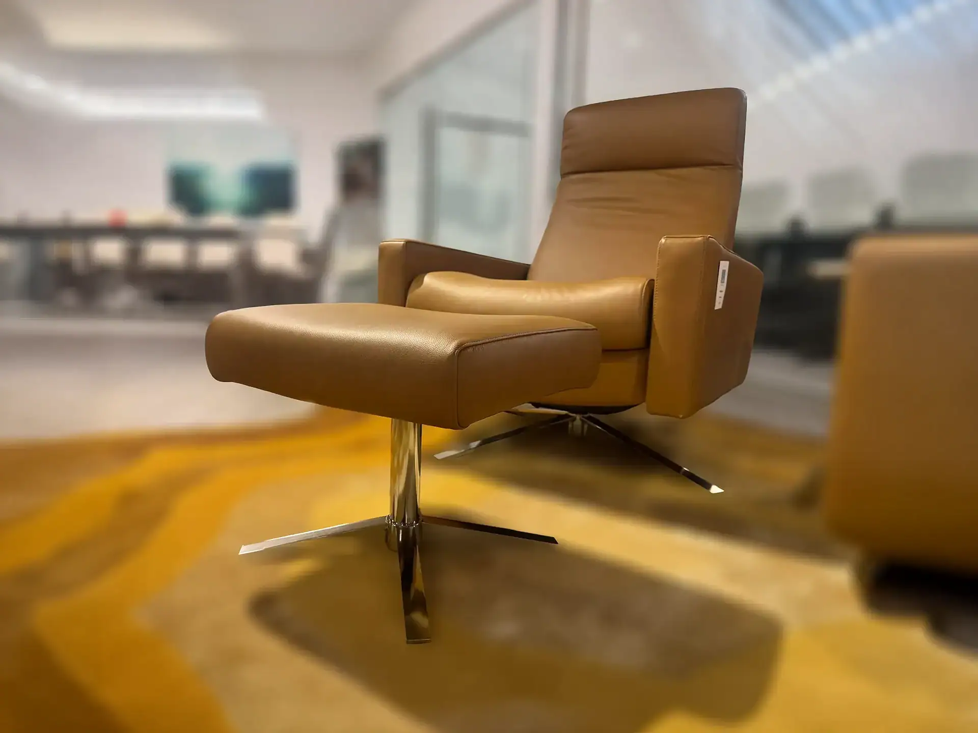 American Leather Cloud XL recliner in tan leather in showroom setting.