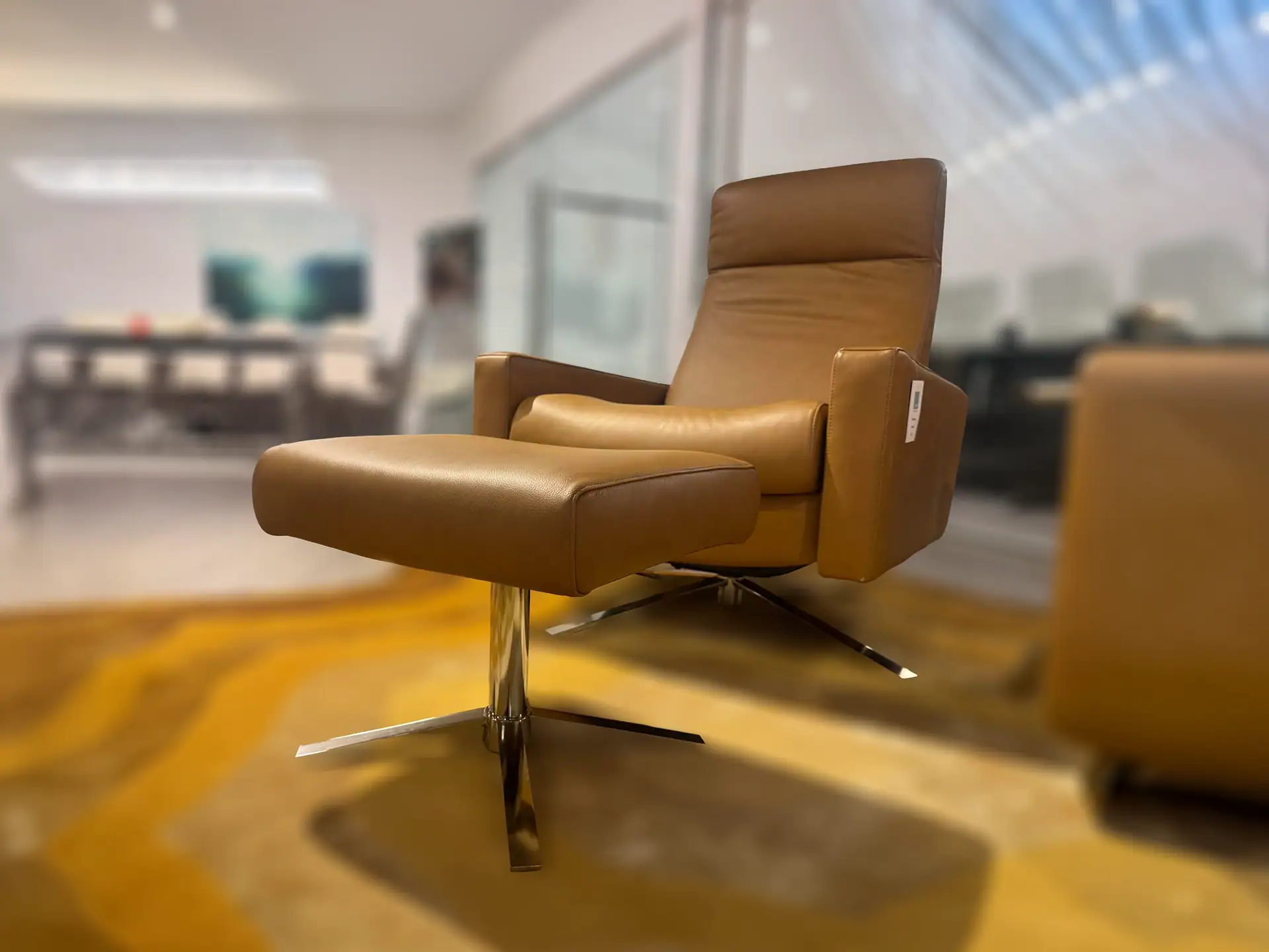 American Leather Cloud XL recliner in tan leather in showroom setting.