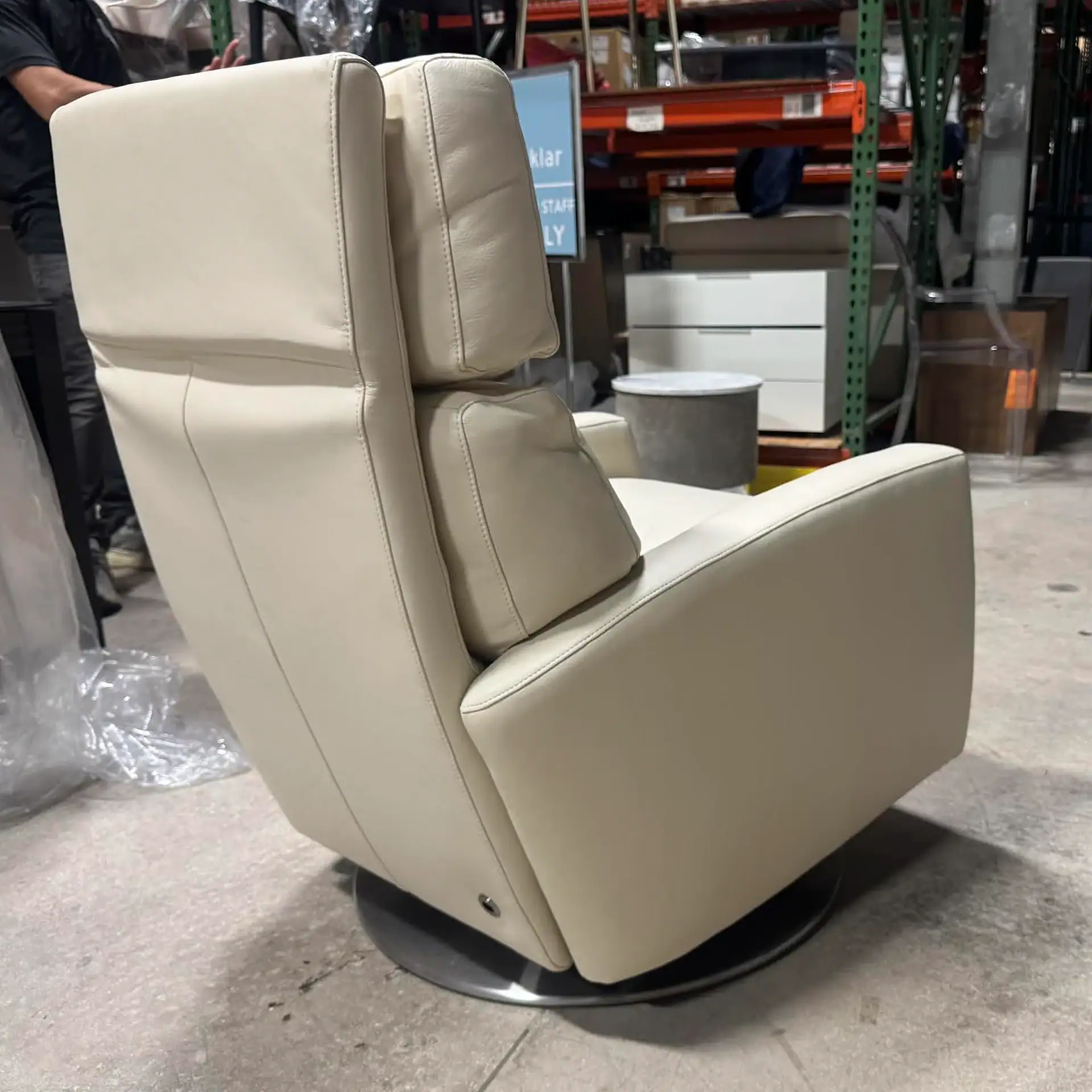 American Leather Demi Recliner in cream color in warehouse setting.